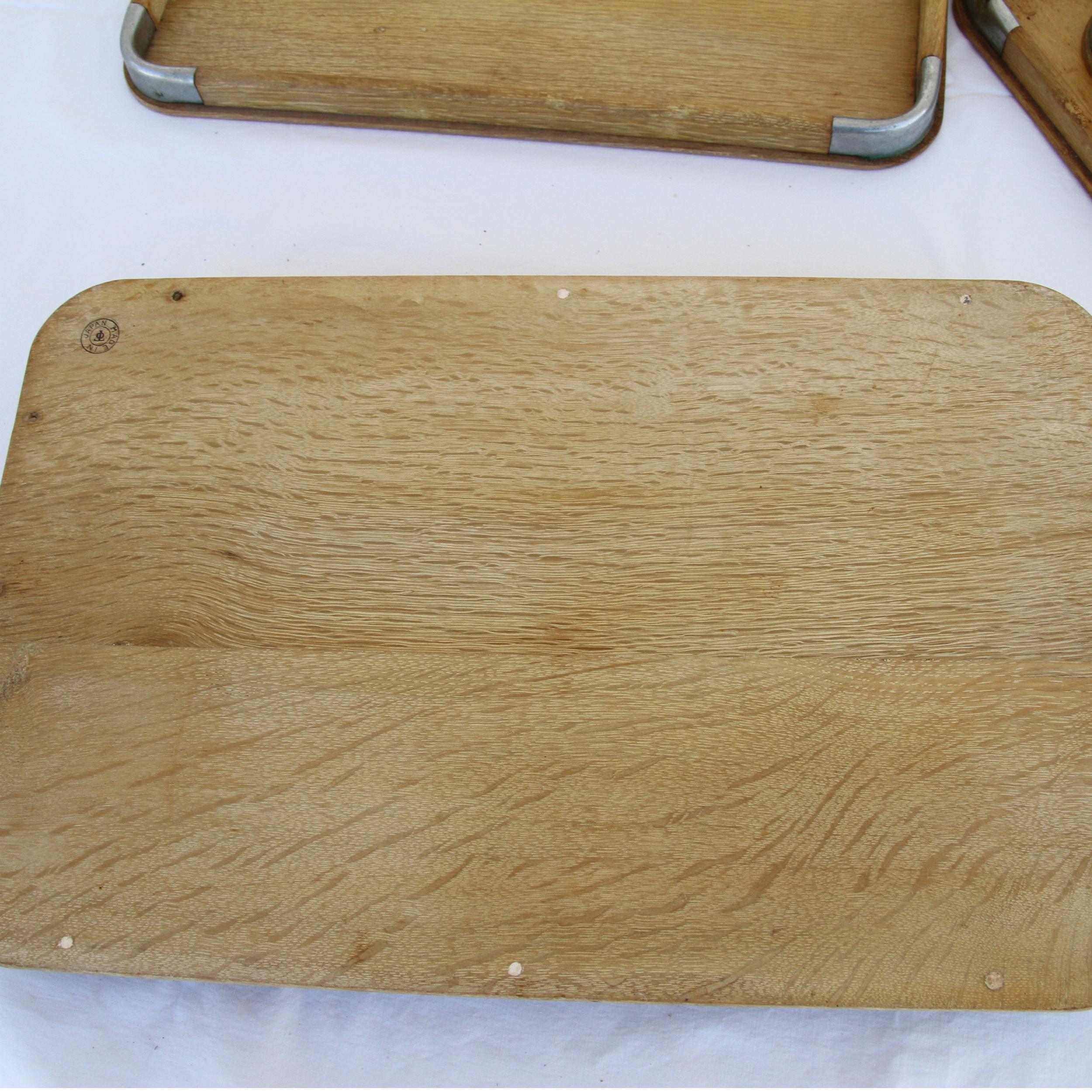 This is a set of 6 Japanese nesting style serving trays. They are made of wood and have metal accents on the corners.