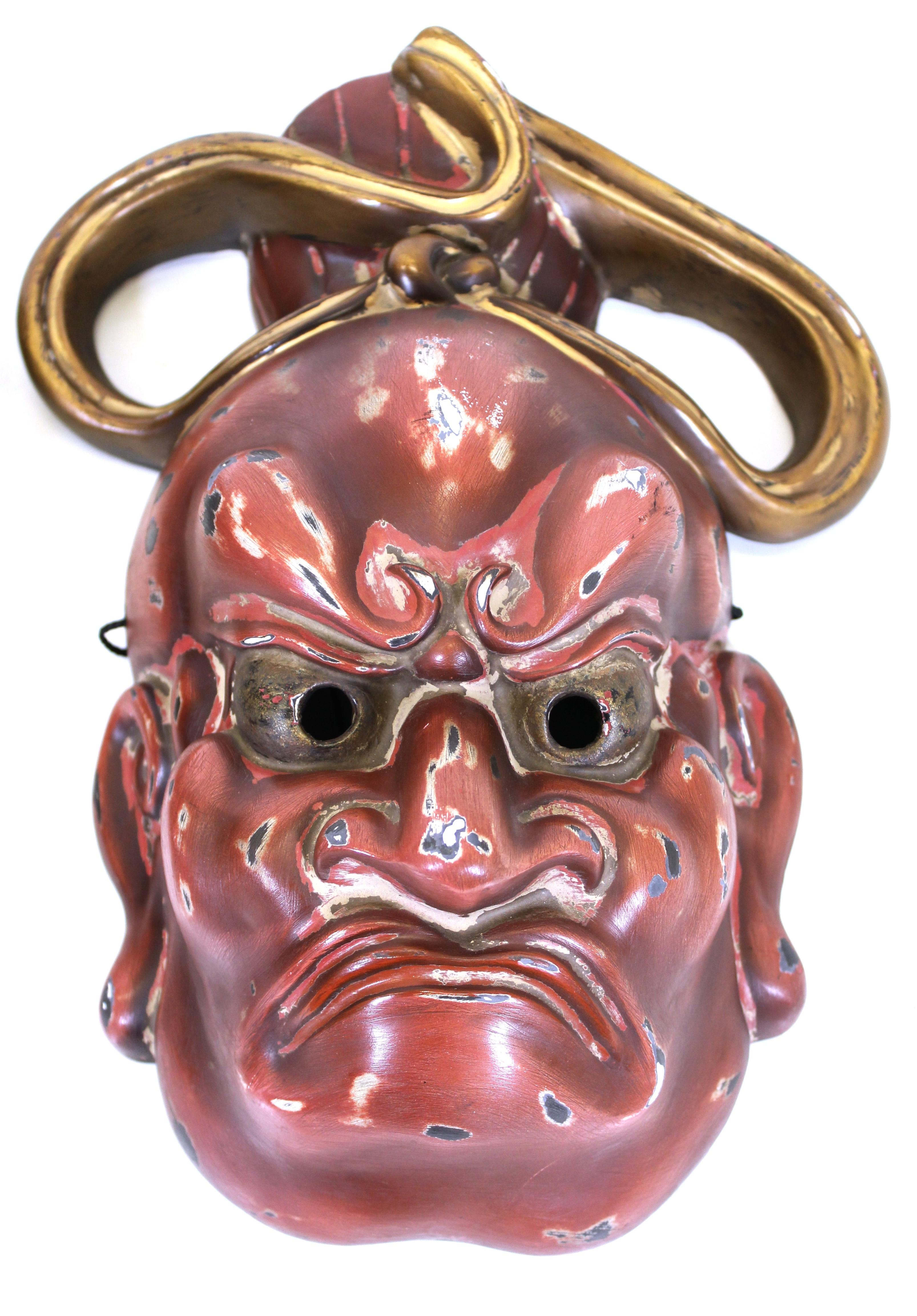 Japanese pair of Nio Buddhist temple guardian masks in finely carved and lacquered cypress wood, with signed labels on the inside, early 20th century, circa 1920. 
A pair of protectors, one on either side of the entrance to the temple, the Nio are