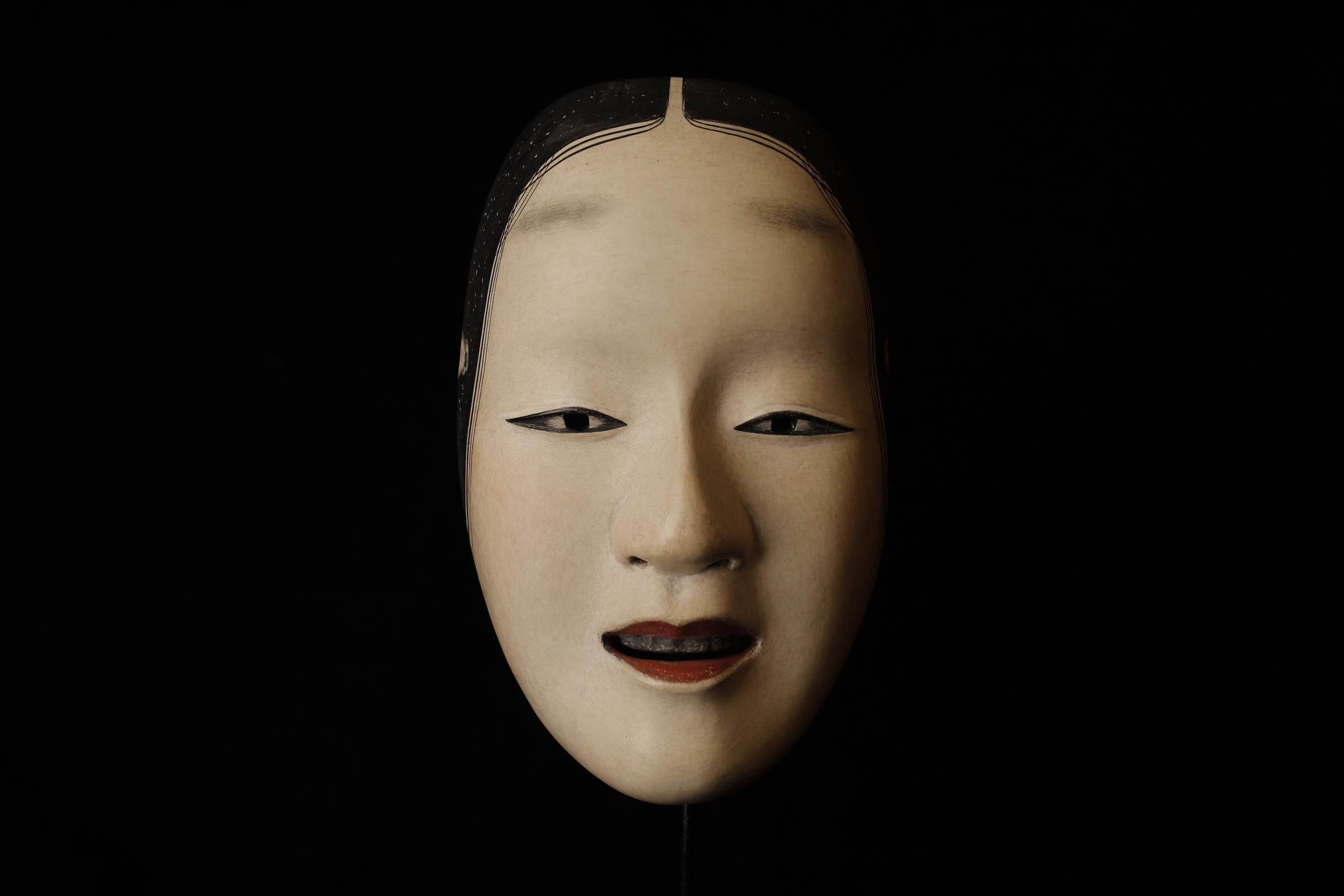 Zō-onna (増女)

This mask depicts a woman with a noble and calm expression. In Noh theater, it is used for roles of young women. The mask conveys elegance and softness, making it suitable for roles related to female characters. There is a theory that