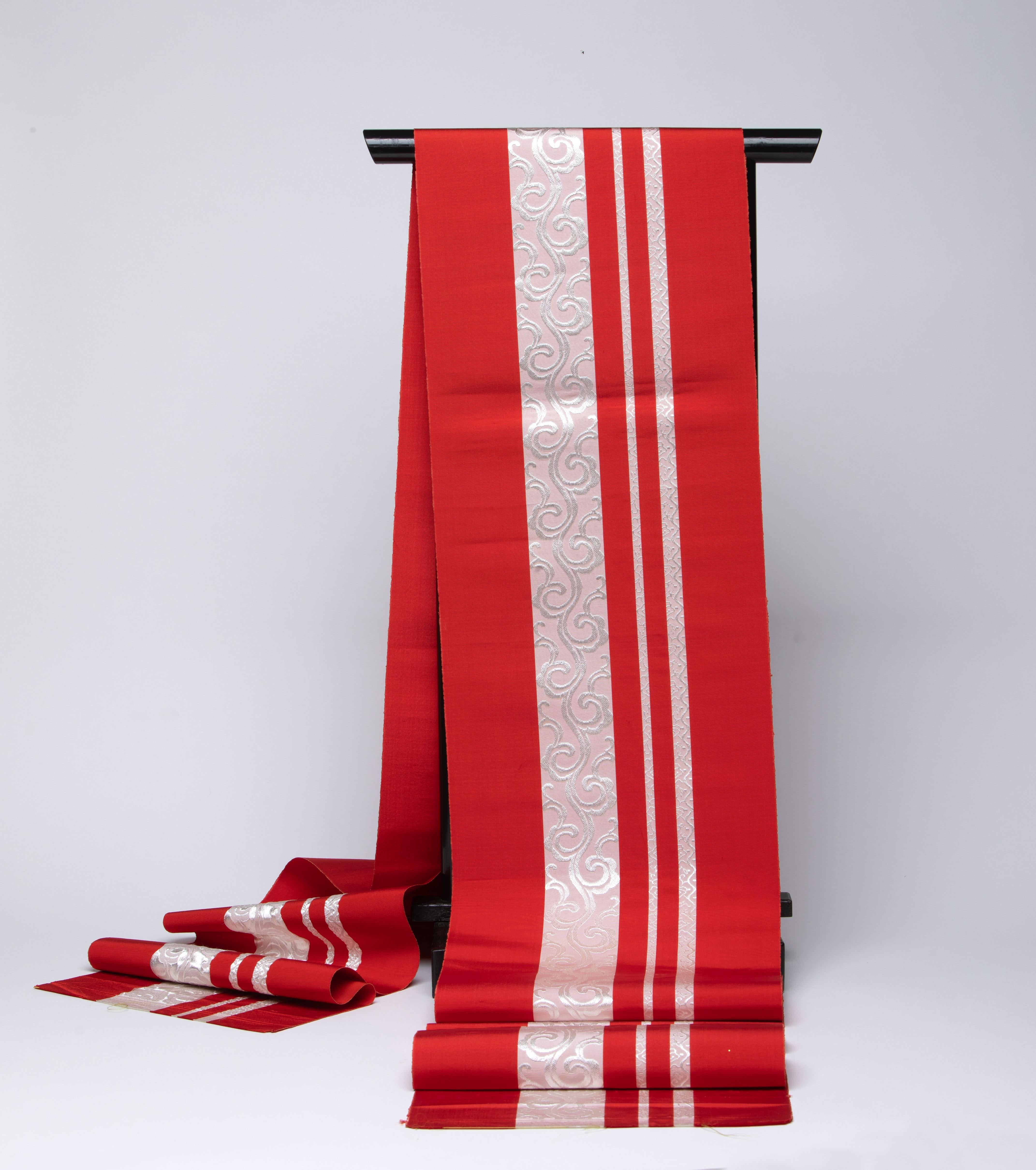 Red and White Brocade Design on a tightly Woven Fabric.
The Brocade Design running the entire length of 150 inches.
White Silk Thread Design is high-lighted on the Red Fabric.
Wonderful hanging on a wall or as a table runner for the holiday