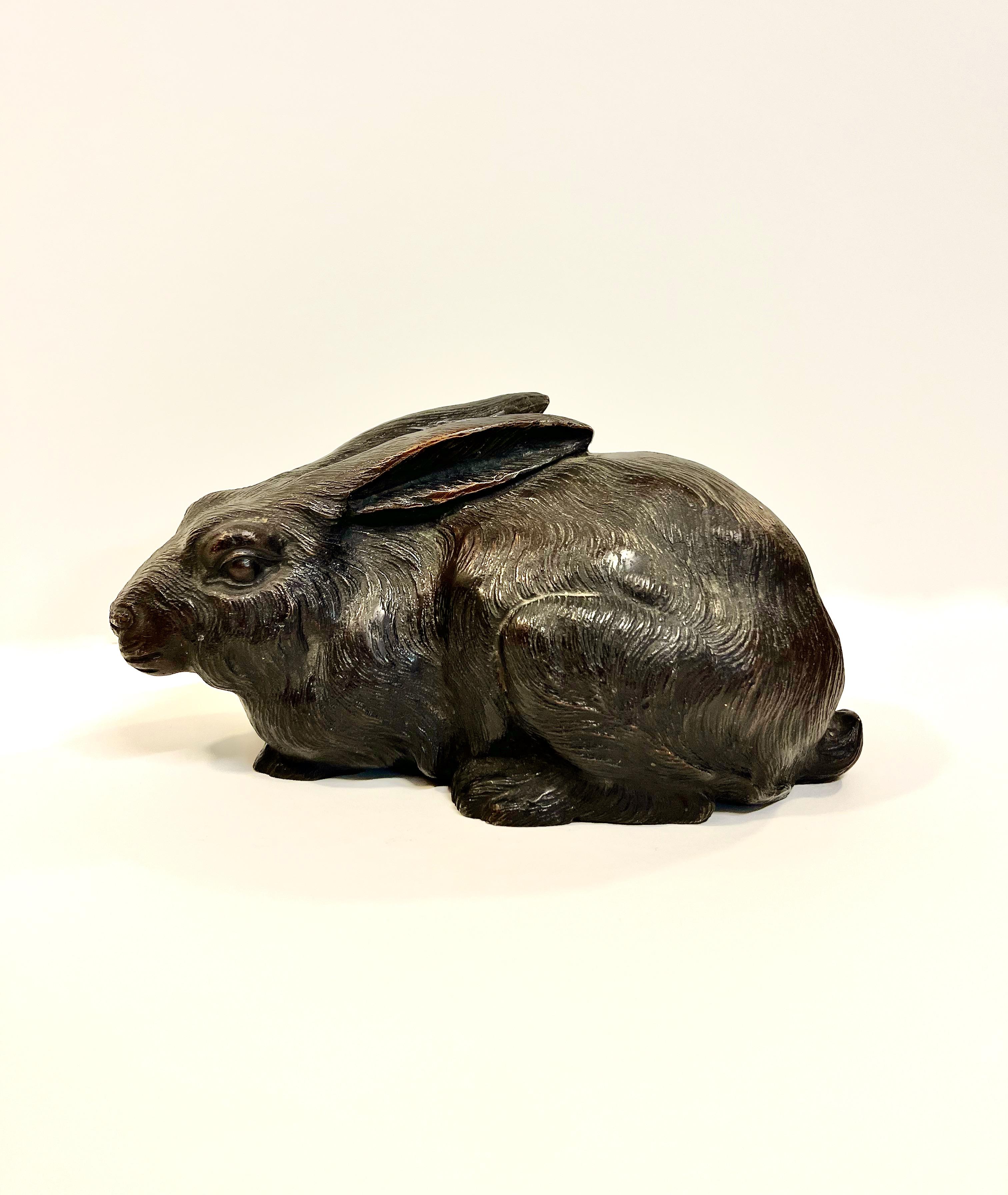 This is an impressive Okimo of a rabbit in a resting position. The bronze is very well cast in the form of a realistic rabbit. The bronze is signed on the bottom of one foot, as shown in photo. It is thought that having a rabbit in the house would