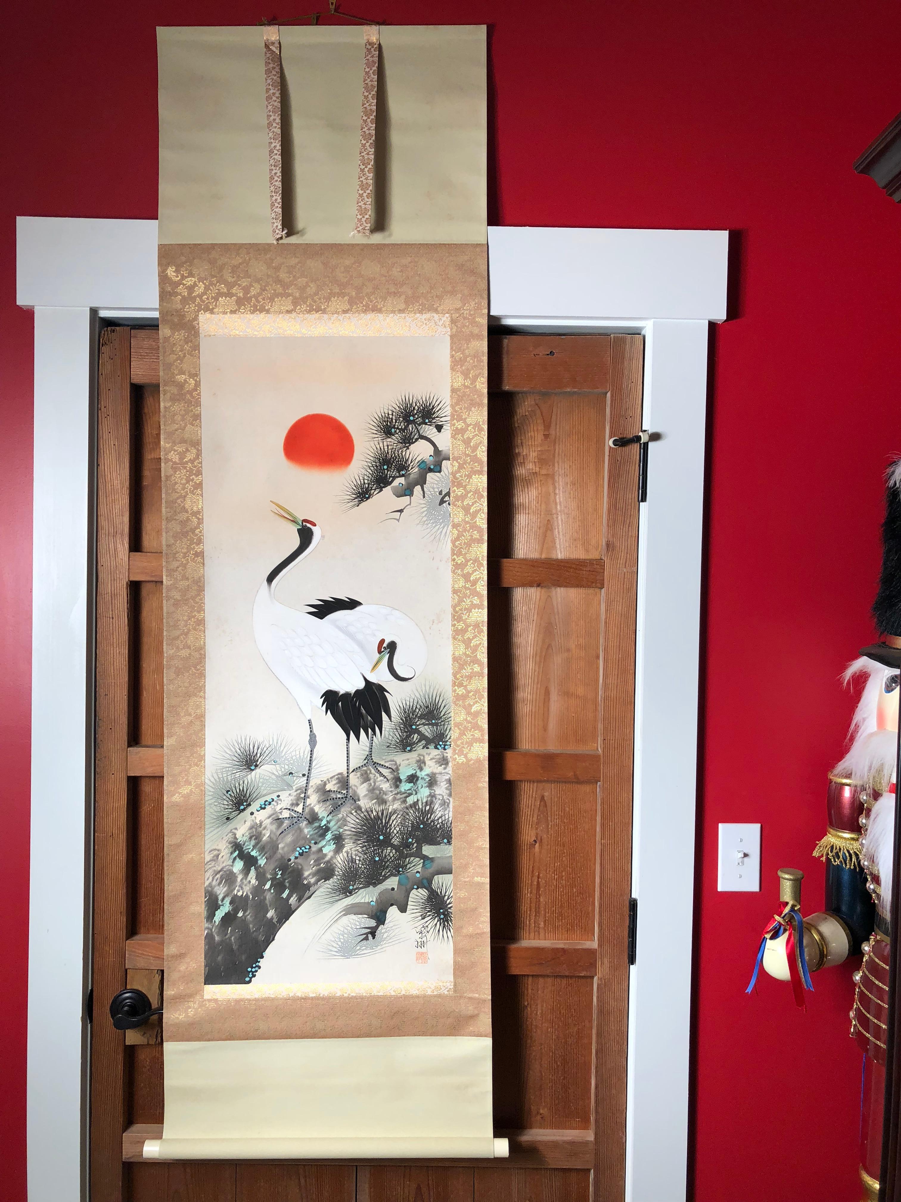 A beautiful and compelling Japanese antique hand-painted scroll of a brilliant sun with a serene pair of conjugal cranes- scroll worthy of your favourite room.

Hand painting on silk in simple classic Japanese striking soft pleasing colors,