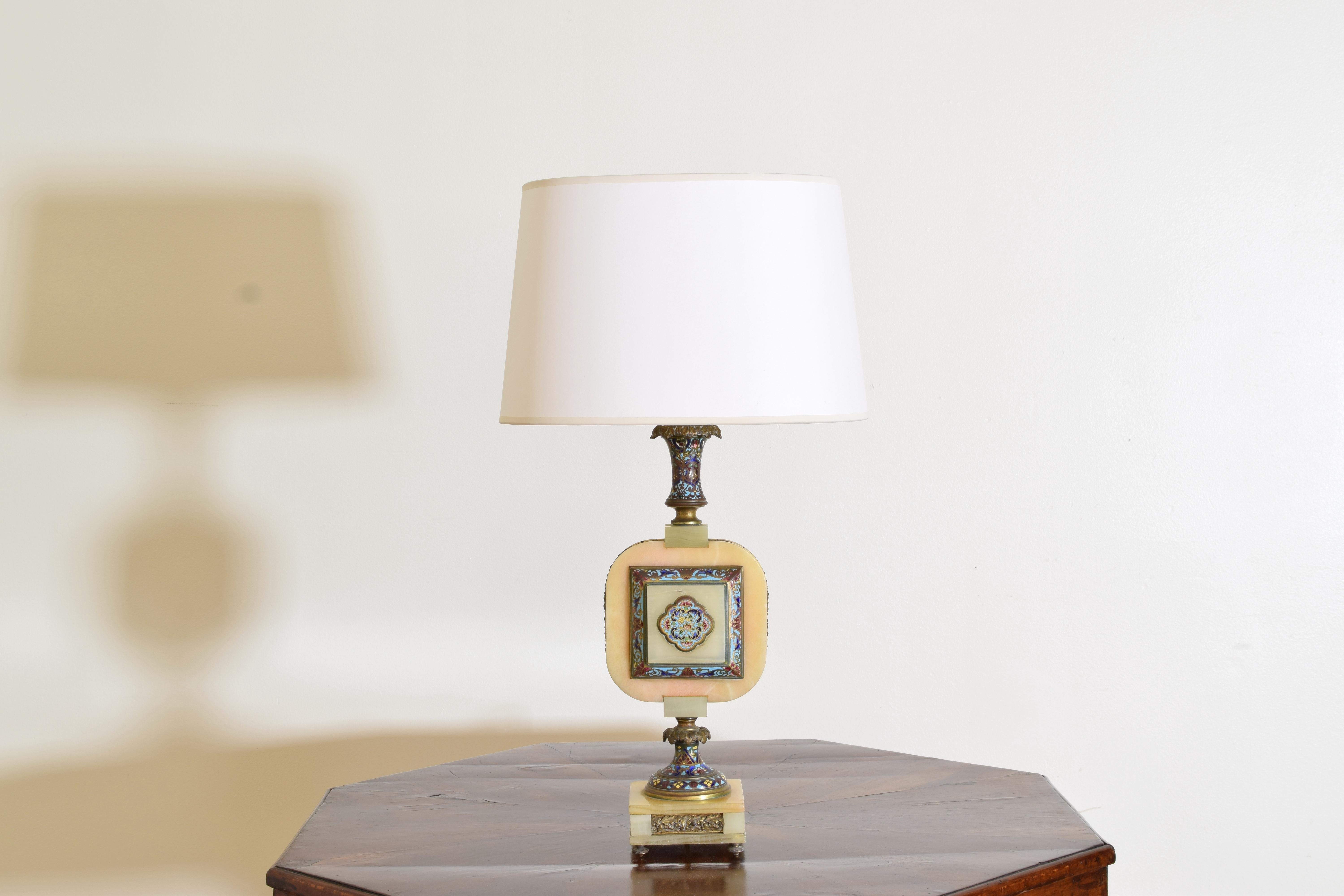 having a square onyx base with brass feet below a shaped socle, the lamp a series of onyx and cloisonne sections.