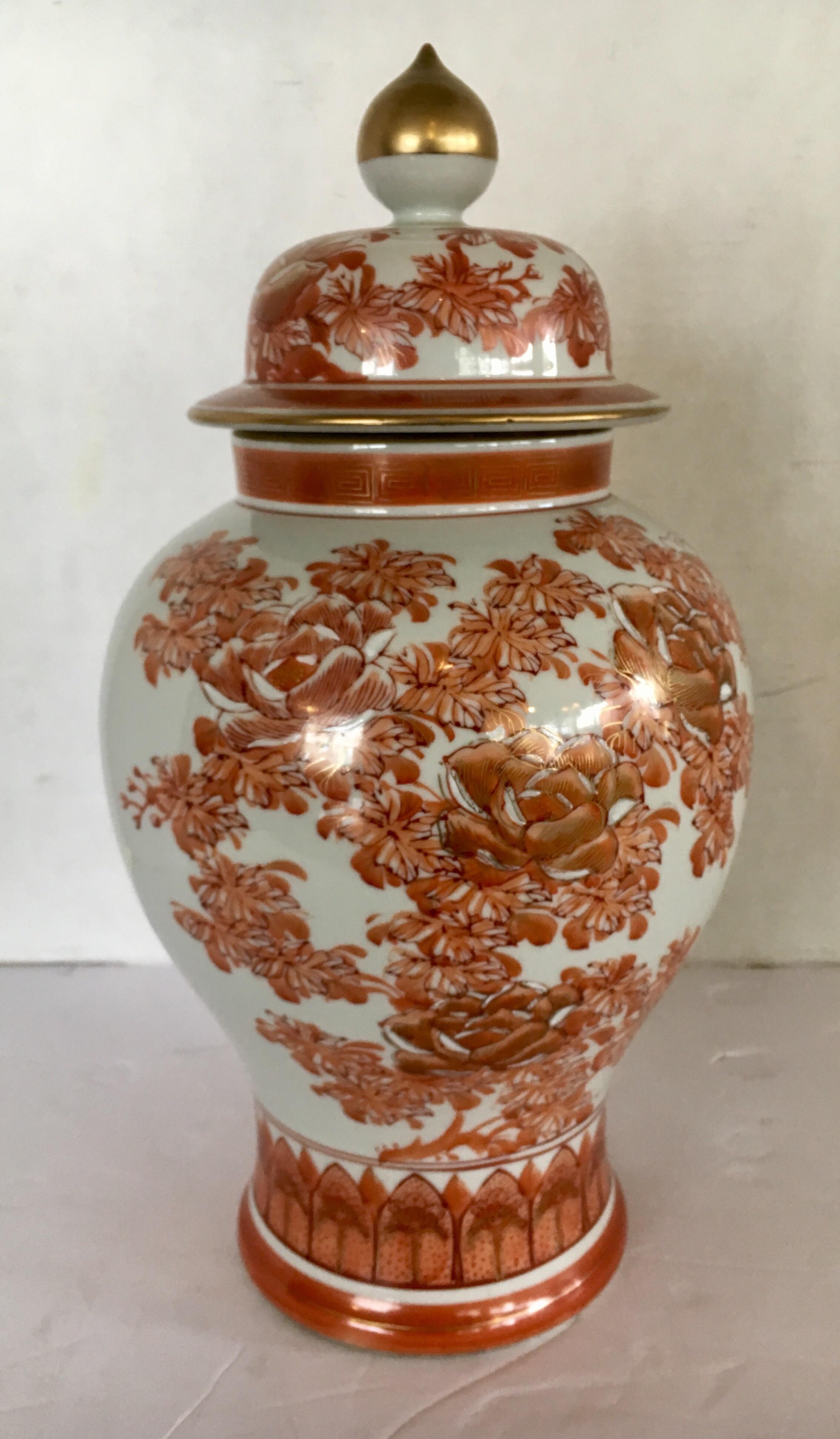 Japanese porcelain ginger jar with cover that has a painted Hermes orange motif on white ground. Signed on the bottom.