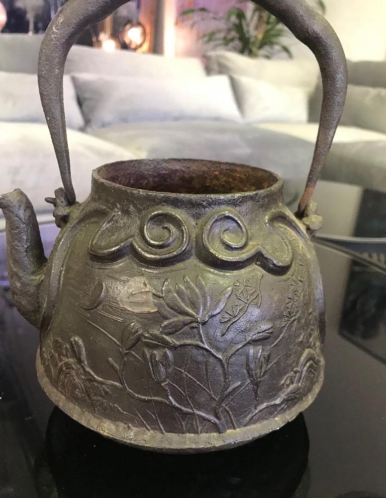 A wonderfully decorated with natural floral patterns, fairly heavy Japanese cast iron teapot tetsubin without top (perhaps designed this way). The pattern and design on the piece is spectacular. 

Likely late 19th-early 20th century.

From a