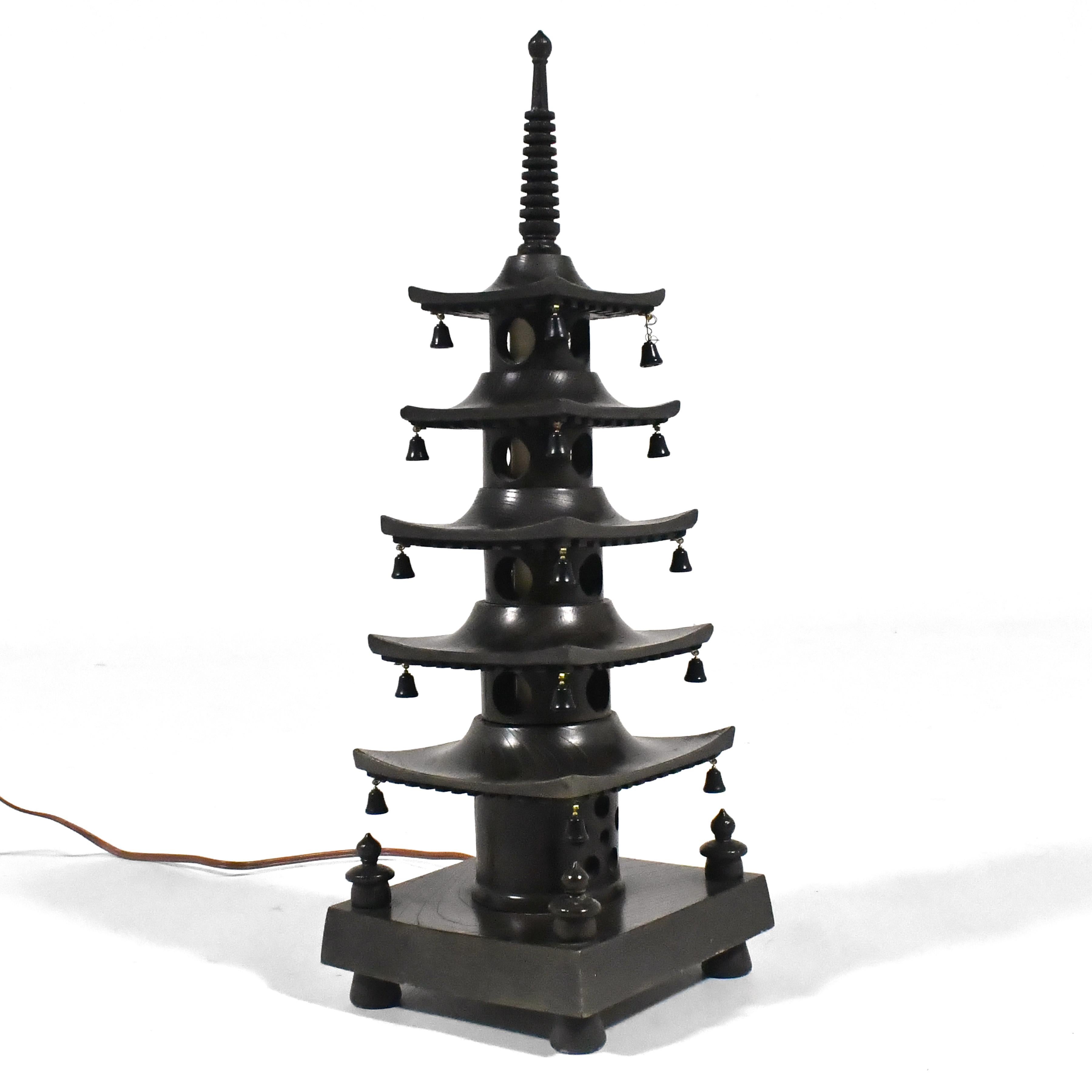 This lovely little lamp in the form of a Japanese pagoda, adds a charming touch to any room. An internal light glows from within, illuminating the windows.

Made in Japan and marked with label on the bottom.

19