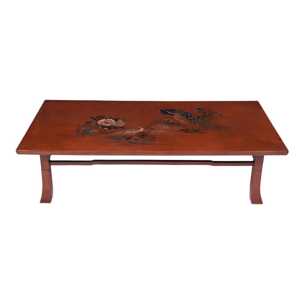 An extraordinary 1960s Japanese coffee table hand-crafted out of solid wood in a good condition and has been newly restored by our team of expert craftsmen. This elegant table has a rectangular top a hand-painted female and male peacock, and peonies