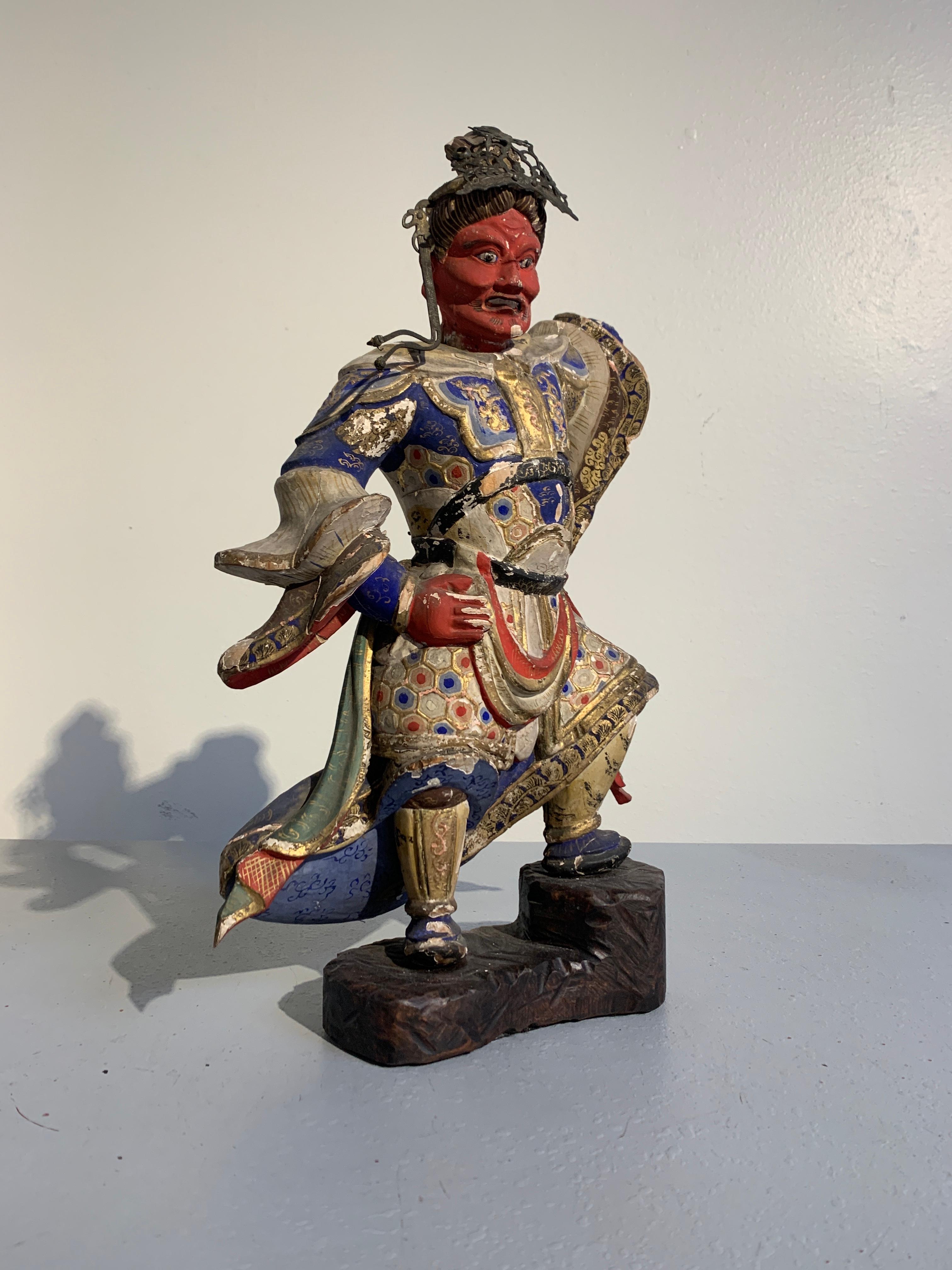 A striking Japanese carved and painted wooden temple figure of a Buddhist Heavenly King, Edo Period late 18th century. Although he is missing his identifying attribute, based on his stance and color of his face, it is most likely that this sculpture