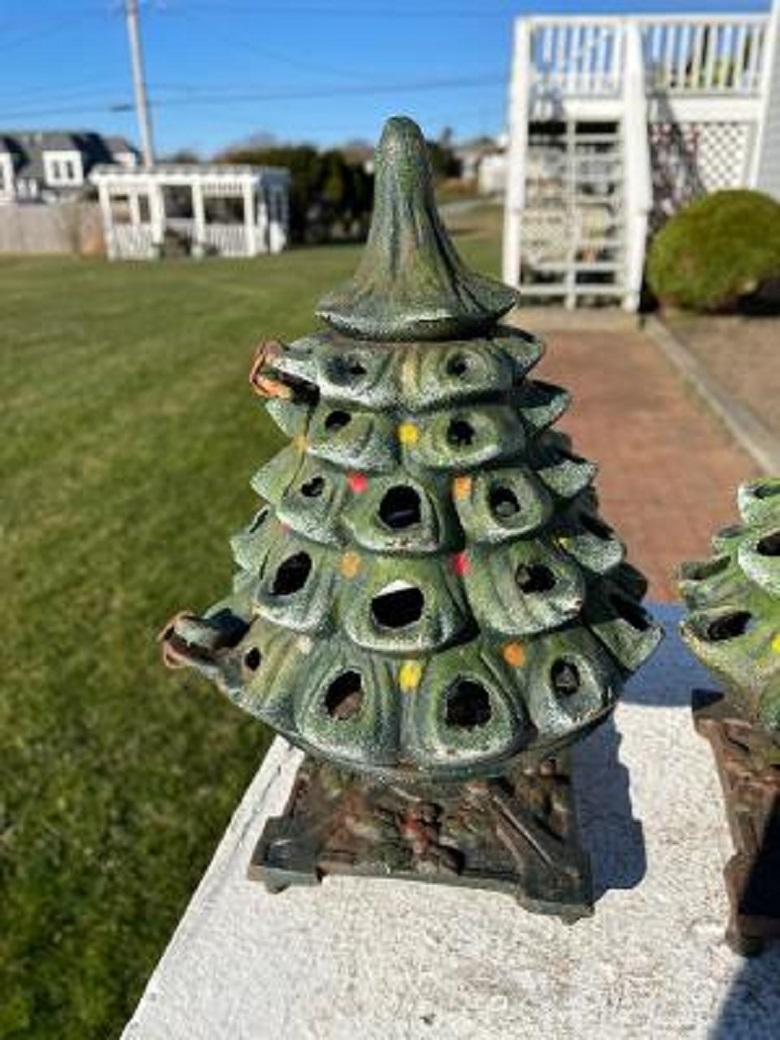 First we have seen

original painted surfaces.

This striking antique pair (2) of unusual hand painted evergreen tree lighting iron lanterns complete with their original decorative holly embossed square bases remind us of the holidays and gifts