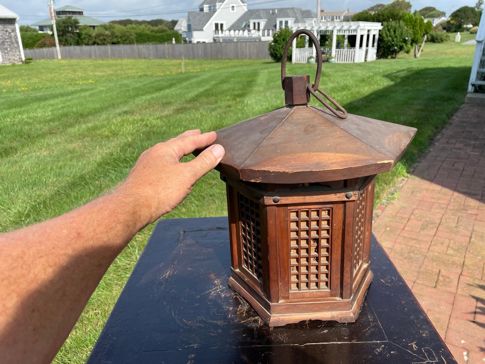 Beautiful pair (2) tall hand carved hexagonal shaped solid wood door panel lanterns- rare survivors and in wonderful condition and possessing their original paper liners. Hand carved from solid cedar wood, they may be perfectly displayed in your