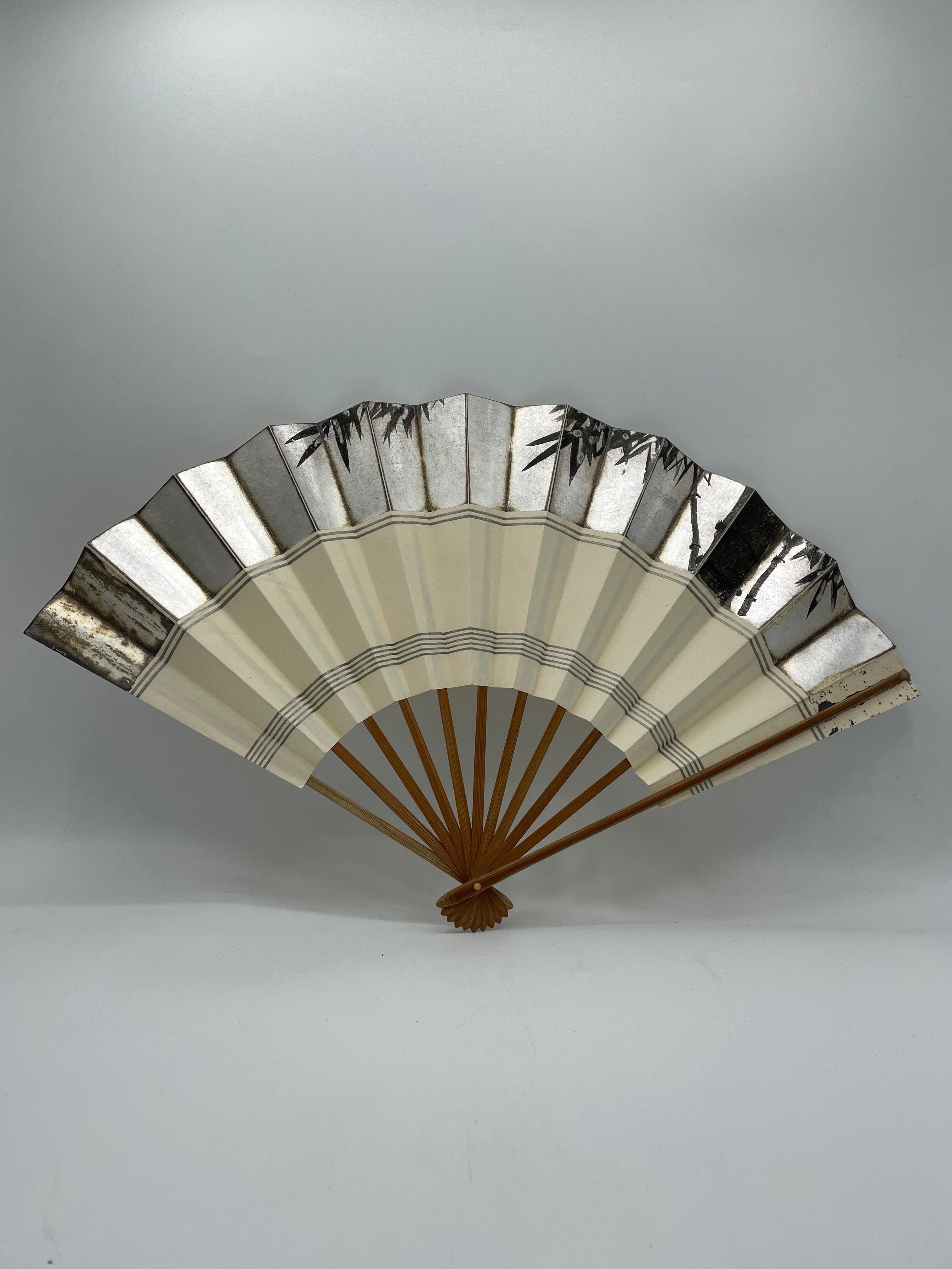 This is a fan which was made in Japan around 1980s in Showa era.
This fan is made with bamboo and paper. It is hand painted.

Dimensions:
3 x 46 x H27 cm 

Japanese fans are made of paper on a bamboo frame, usually with a design painted on them. In