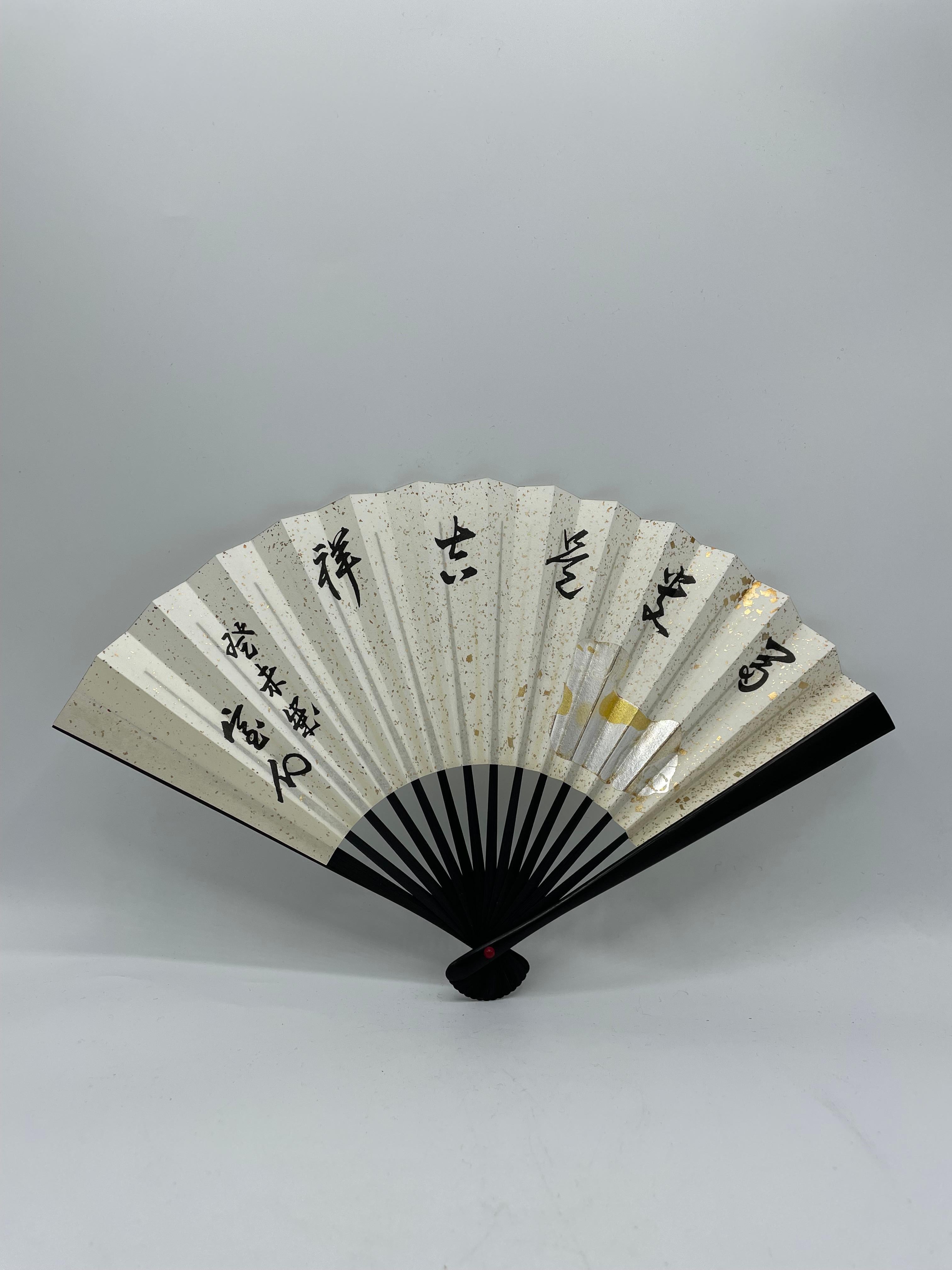 This is a fan which was made in Japan around 1990s in Heisei era.
This is made with a paper and bamboos.

Japanese fans are made of paper on a bamboo frame, usually with a design painted on them. In addition to folding fans (ōgi), the non-bending