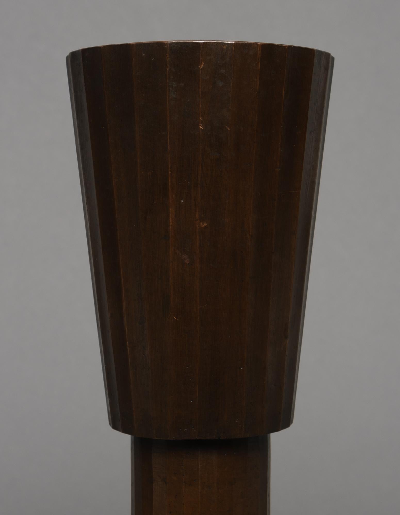 Striking dark brown patinated bronze vase in an hourglass shape with vertical ribs.
Cuppa-shaped insert on top with six concentric ridges.

When shipped we will add a certificate of authenticity.
Price including insured shipping.