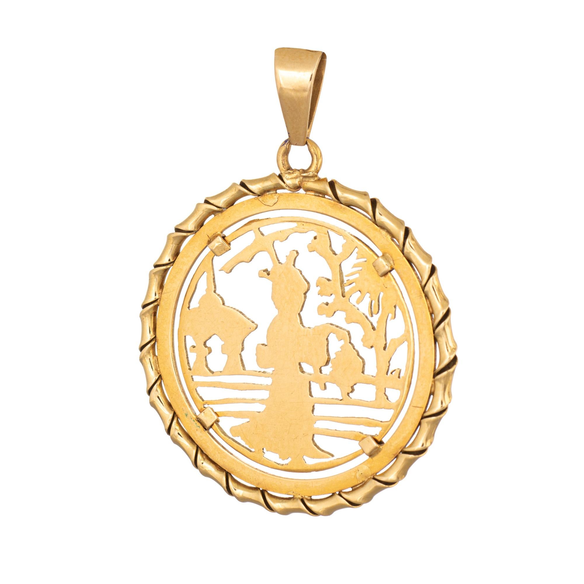 Finely detailed vintage Japanese pendant crafted in 18k yellow gold.  

The pendant features a Kimono clad figure carrying a lantern with a Temple and Cherry Blossom backdrop. The pendant is bordered with a tubular ribbon style design. Ideal worn as