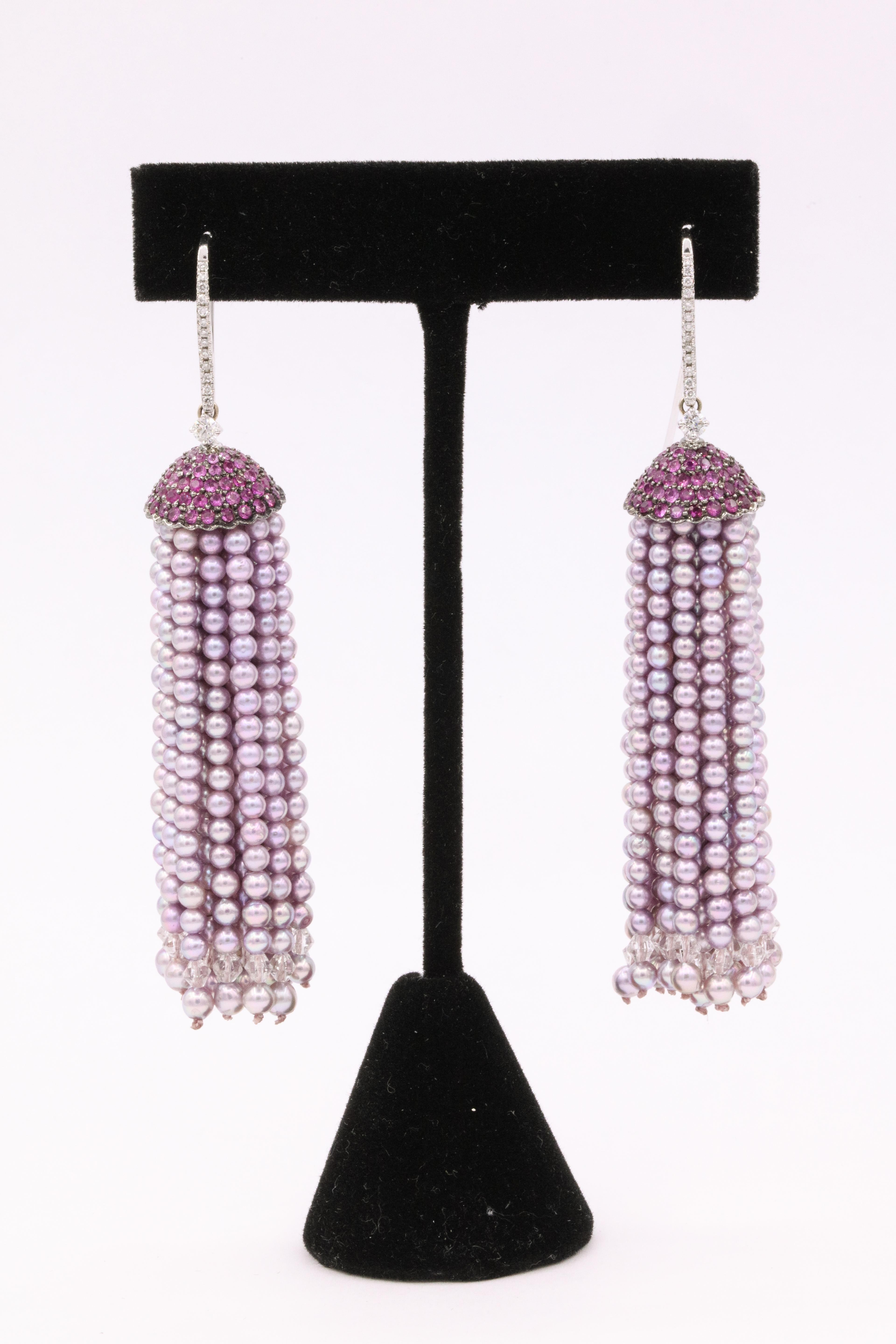 These fun earrings feature 40 strands of enhanced Japanese pink Akoya Pearls with a diamond bale, 0.30 atw, and pink sapphire caps weighing 4 atw, in 18k white gold. 