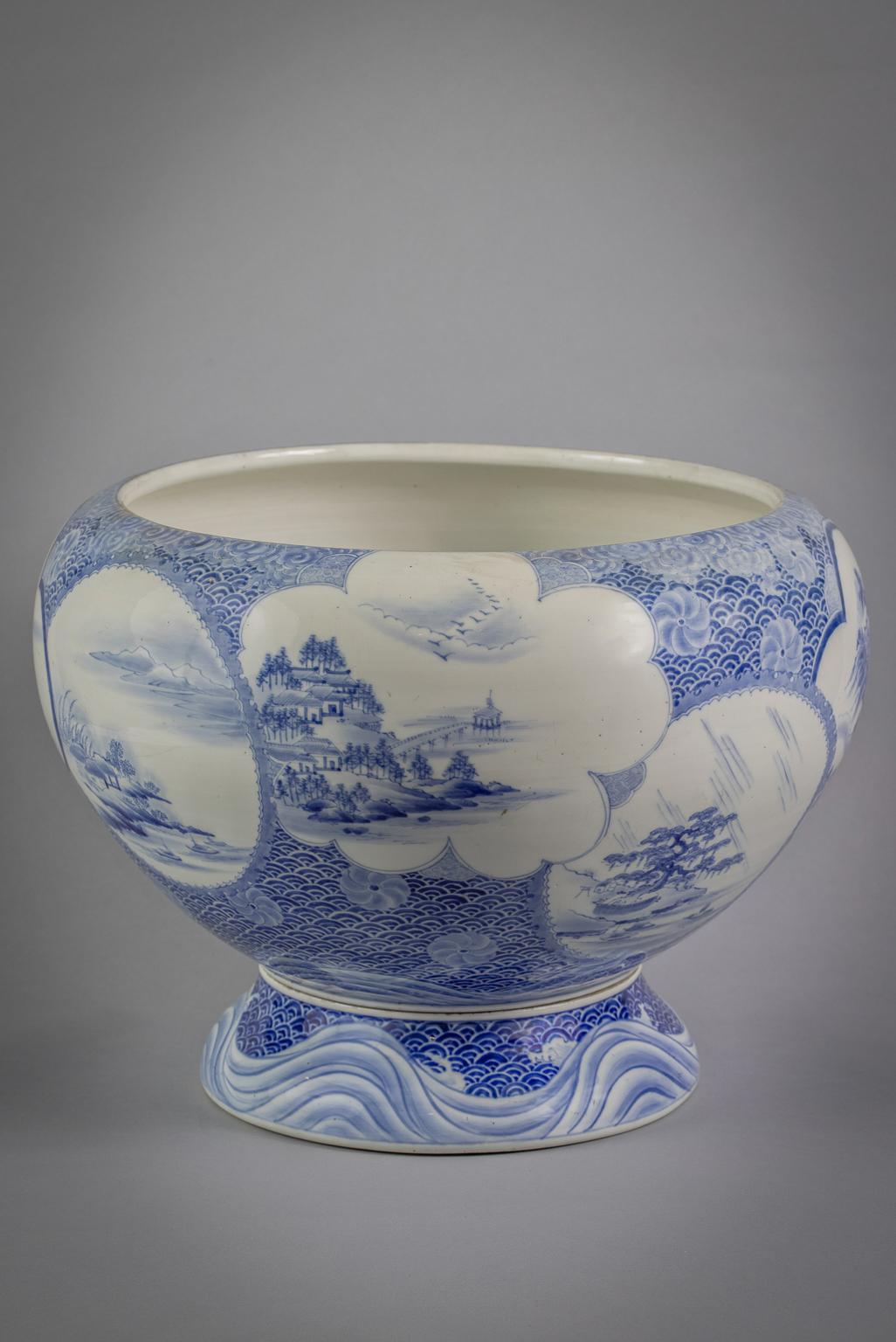 Japanese porcelain blue and white fish jardiniere on stand, circa 1890.