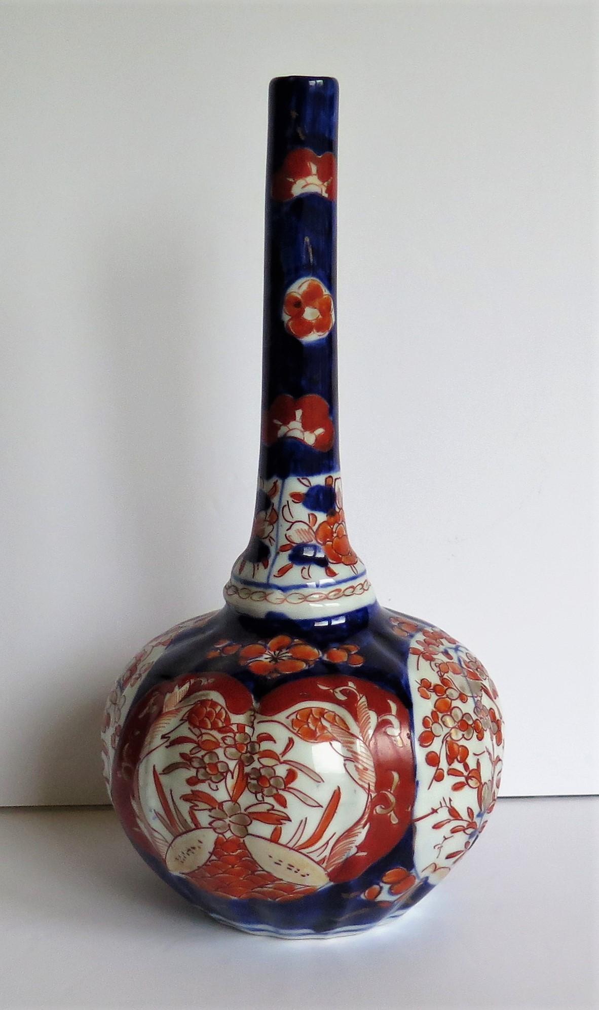 This is a very decorative Japanese bottle vase which we date to the early Meiji period of the 19th century, circa 1875.

This vase has a distinctive bottle shape with a tall stem neck having a shaped basal knop (swelling). The bulbous lower section