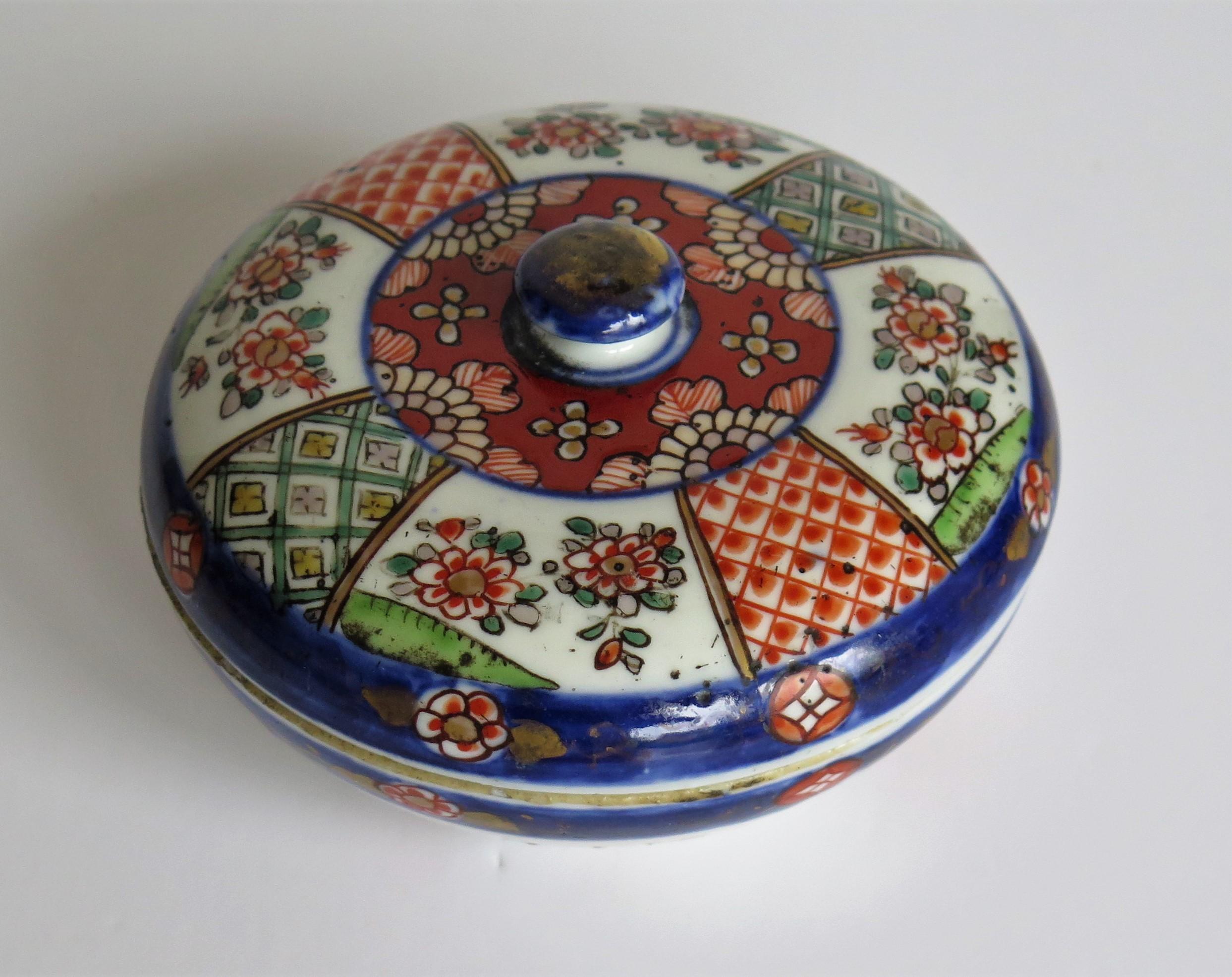 This is a very decorative, circular porcelain Lidded Box, hand painted and made in Japan during the Meiji Period, circa 1880. 

The circular box and lid are well potted, the lid having a small round knob.

The decoration consists of under-glaze