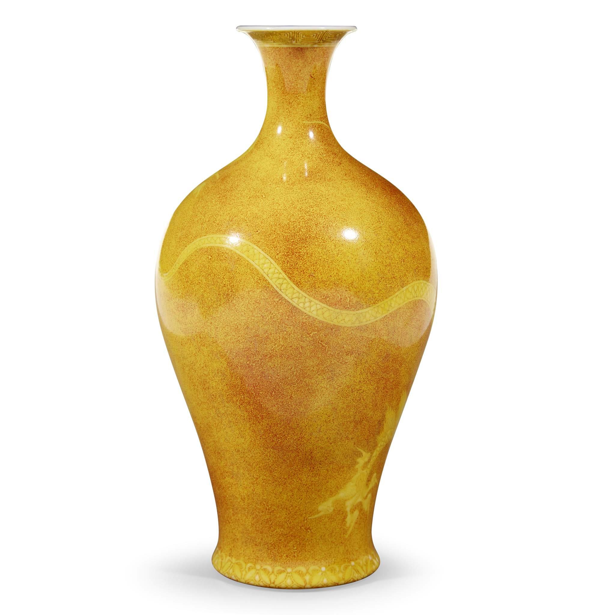 A porcelain vase in brilliant yellow color with dragon motif by legendary Japanese potter Makuzu Kozan (1842-1916) circa 1901. The vase is made in a classic elongated baluster form and decorated in an unusual yellow monochrome enamel. A flying
