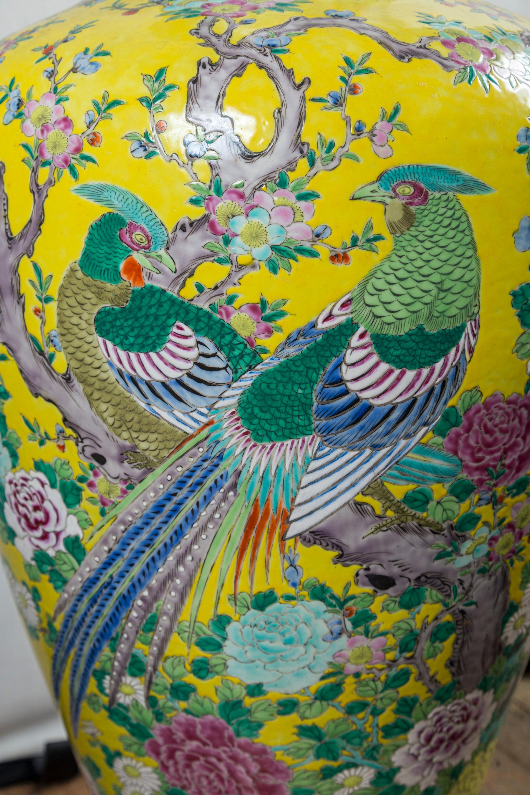 Bright yellow ground decorated with exotic birds and flowers. Dark blue and green bands also decorated. Bright white interior. Marked NIPPON on the underside. The flared open top is 8.75 across.