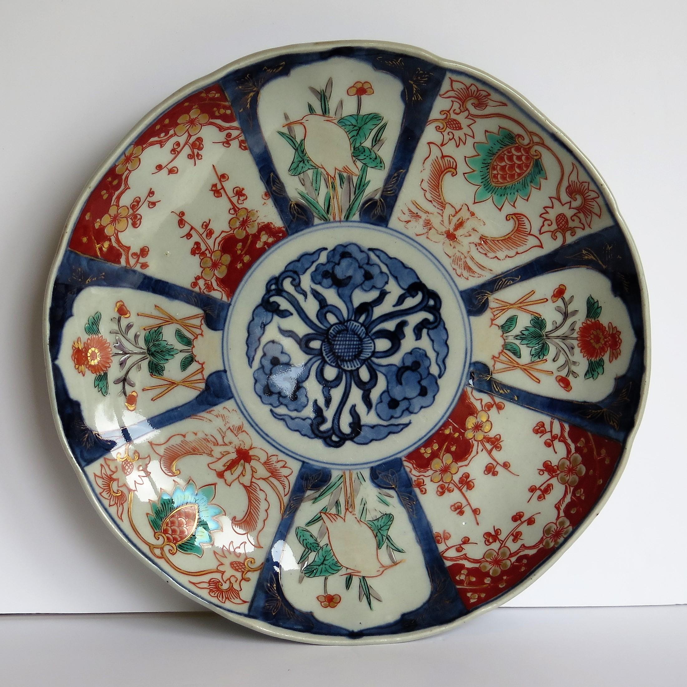This is a nice quality Japanese porcelain Small Charger, large plate or bowl with an Imari pattern, dating to the mid-late 19th century, Meiji period, circa 1870.

The plate or charger is quite deep with a lobed cavetto and rim. 

It is hand