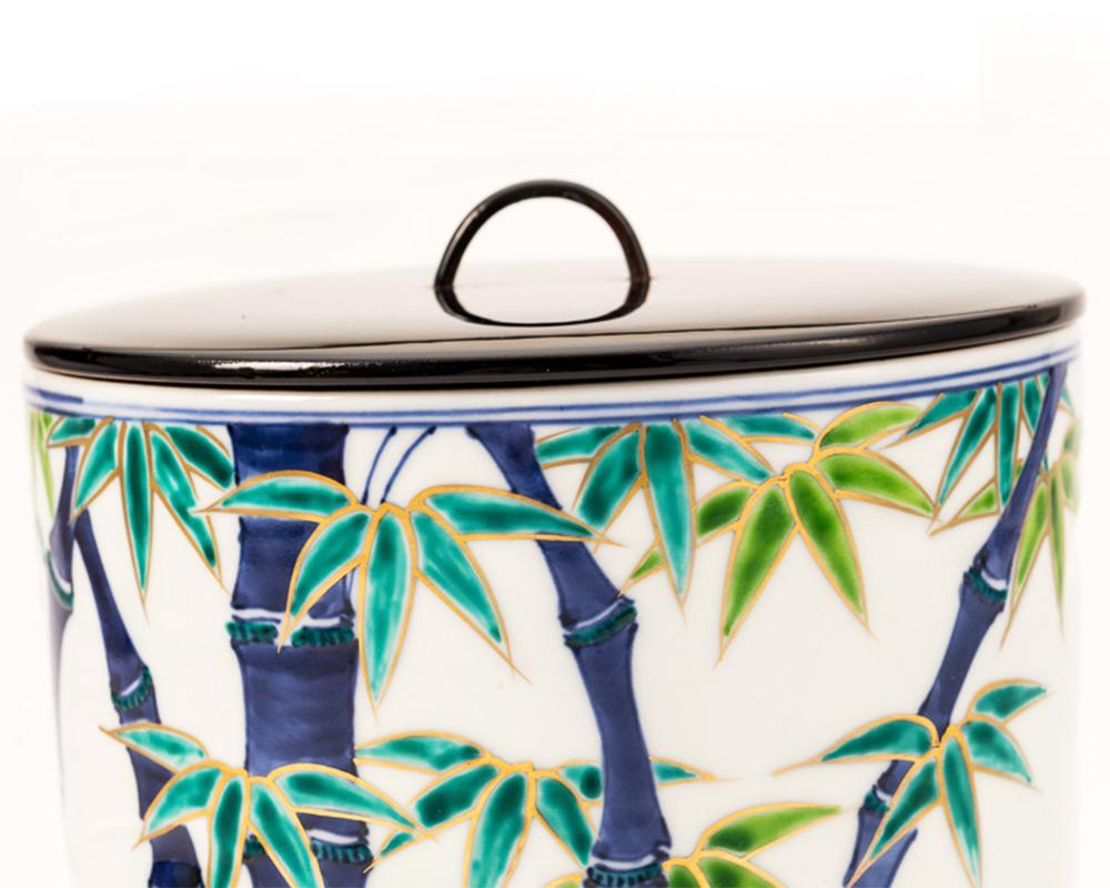 Japanese porcelain pot (MIZUSASHI) with a bamboo motif exquisitely hand painted with a blue underglaze and an over-glaze of green, blue and silver leaves with a black lacquer lid. It comes in it's original wooden box. Mizusashi are traditionally