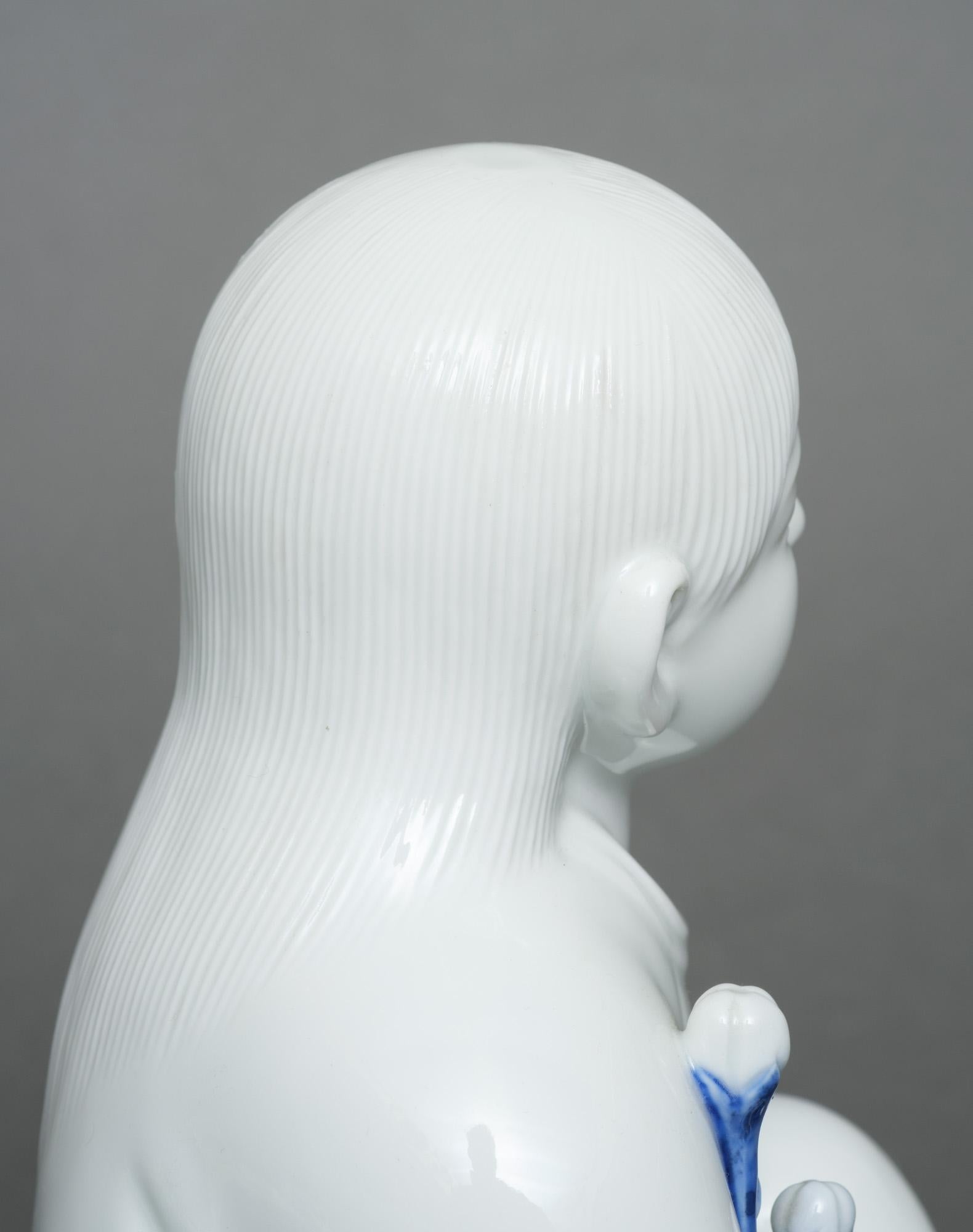 20th Century Japanese porcelain okimono 置物 of a sitting child, by Sakaida Kakiemon XII