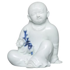 Japanese porcelain okimono 置物 of a sitting child, by Sakaida Kakiemon XII