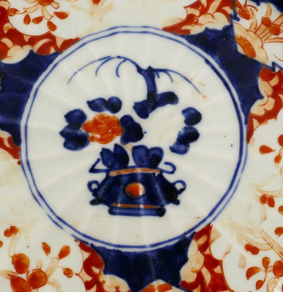 You are admiring a refined Japanese Porcelain plate made by Japan manufacture during the end of the 19th century.

This elegant decorative object is a porcelain wall plate in the shape of flower petals.

With an elegant blue and red decorations