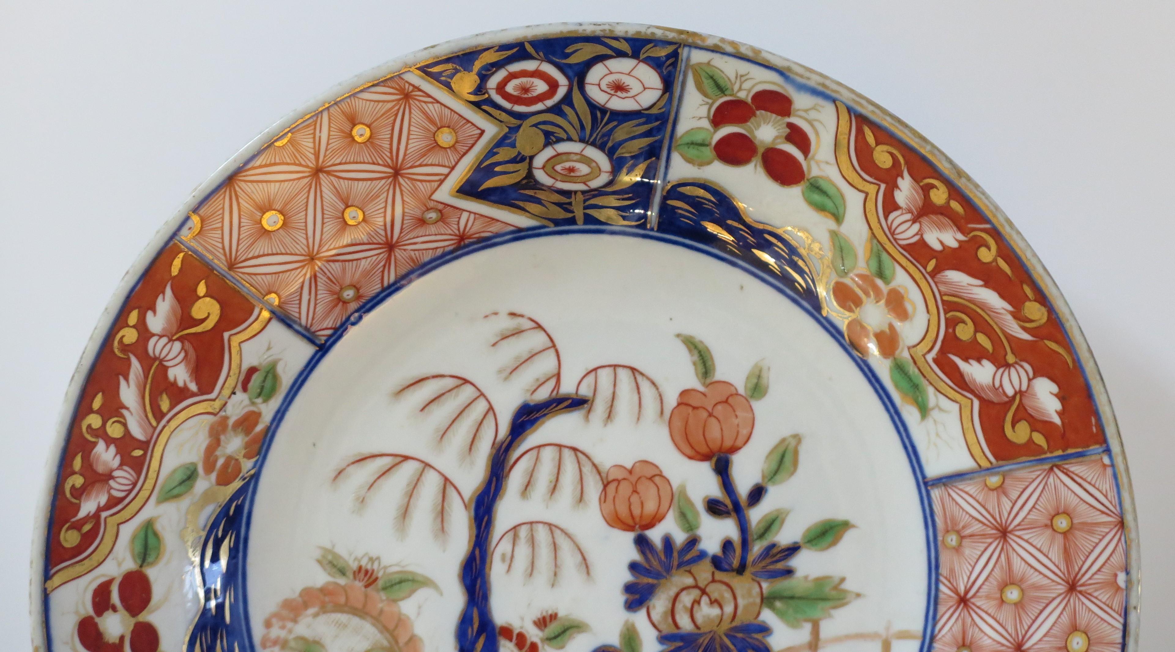 This is a good quality Japanese porcelain plate or dish, which we date to the Edo period, circa 1840. 

The plate is beautifully hand decorated with varying shades of under-glaze cobalt blue, then hand enameled with blue, green, red and burnt