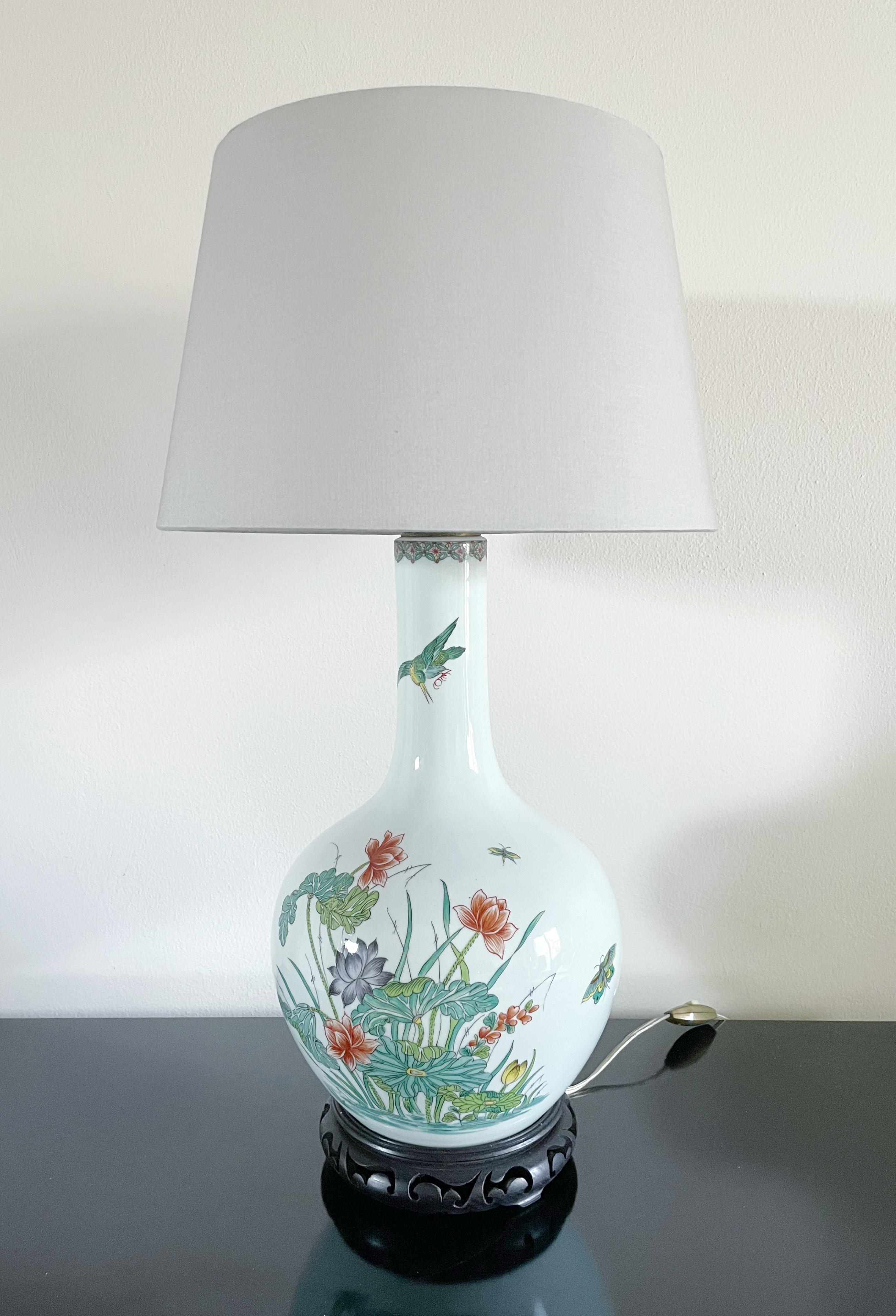 Japanese hand-painted porcelain lamp with lotus motif mounted on black wood base
Dimensions including lamp shade: height 24.5 inches, diameter 17 inches
Dimensions without lamp shade: height 18 inches, diameter 8.5 inches
1 available in stock in