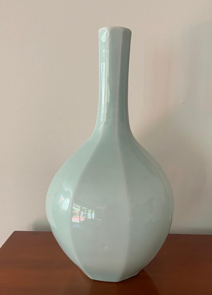 A large pale celadon Japanese Tokkuri (Sake Bottle), signed to base, circa 1900.

The multifaceted bulbous body rising to a graceful slender neck, 17 inches in height.

In very good condition with no scratches, chips, cracks or