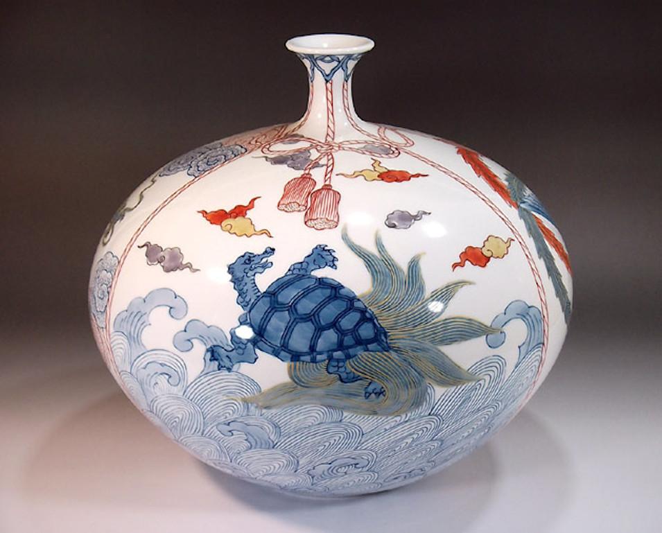 Contemporary porcelain decorative vase, hand painted in blue and red on a beautifully shaped ovoid porcelain body, a signed piece by widely acclaimed Japanese master porcelain artist in the Imari-Arita tradition. In 2016, the British Museum added a