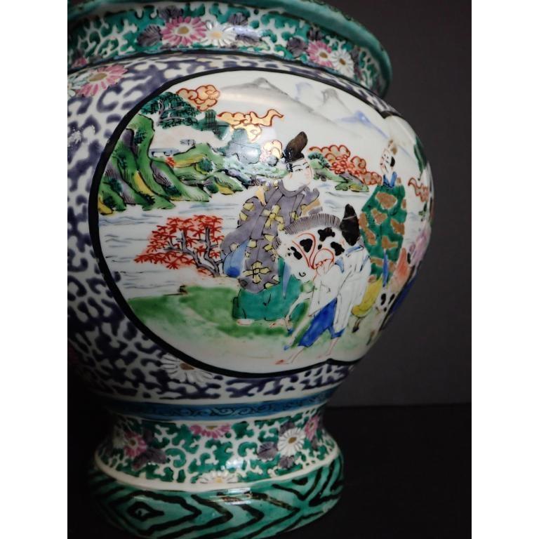 Japanese green and white Porcelain vase with dragon handles, 19th century.
Hand painted ceramic planter with figural and floral design. No noticeable maker's mark.