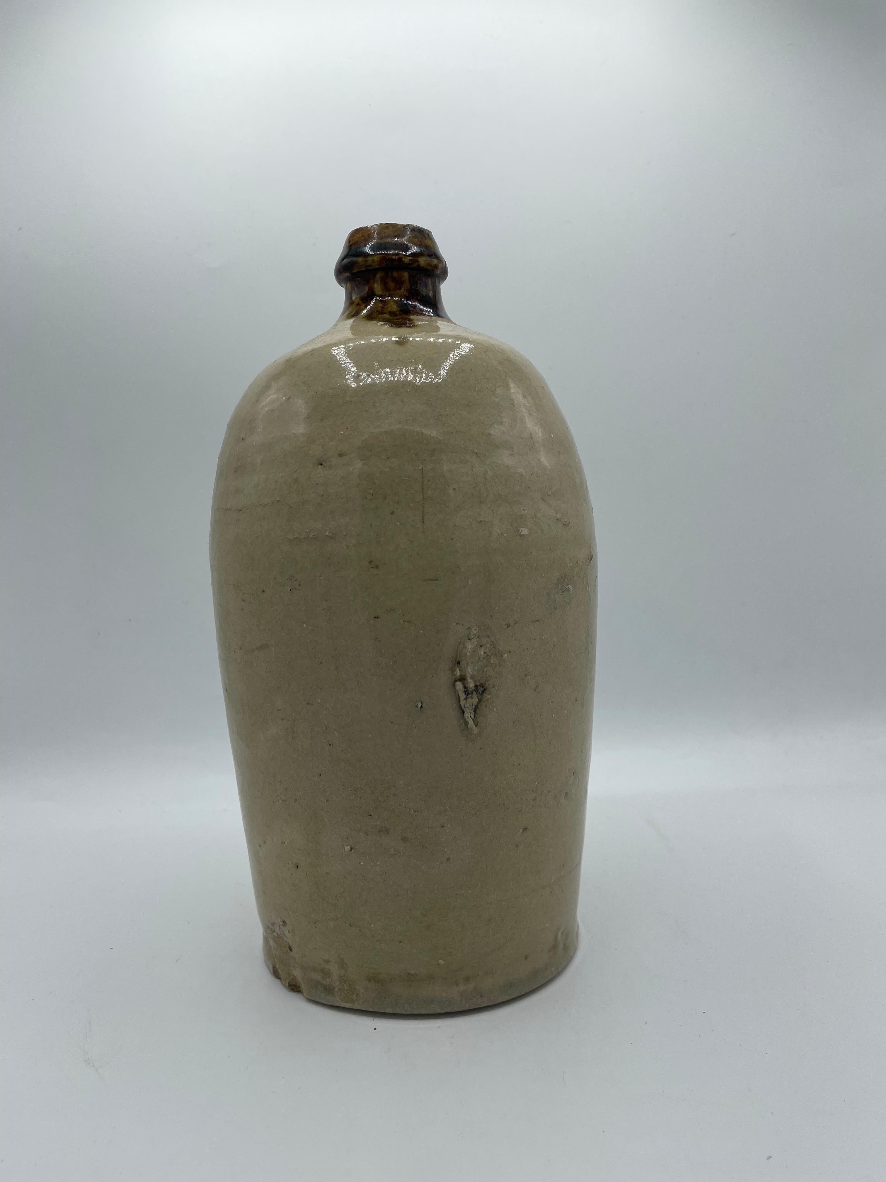 This is a bottle that the people were used to carry sake or soy sauce.
It is made with porcelain and it was made around 1960 in showa era. 
It can use as a flower vase or as a decoration.

Dimensions:
H25 x 14 x 14 cm