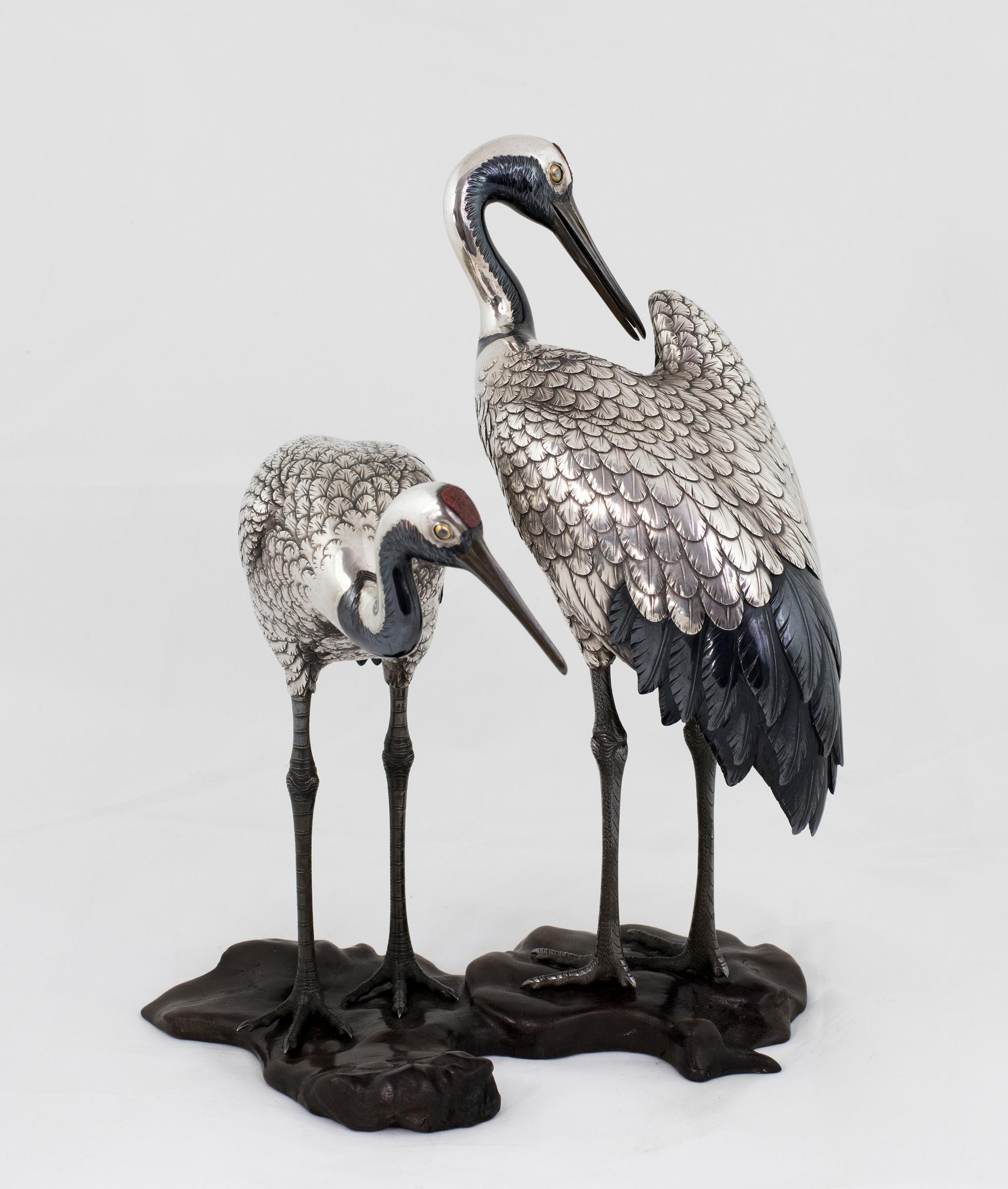 As part of our Japanese works of art collection we are delighted to offer this most charming Meiji Period 1868-1912, pure silver and mixed metal sculptural okimono depicting a pair of Manchurian cranes stood upon a naturalistic wooden base, the base