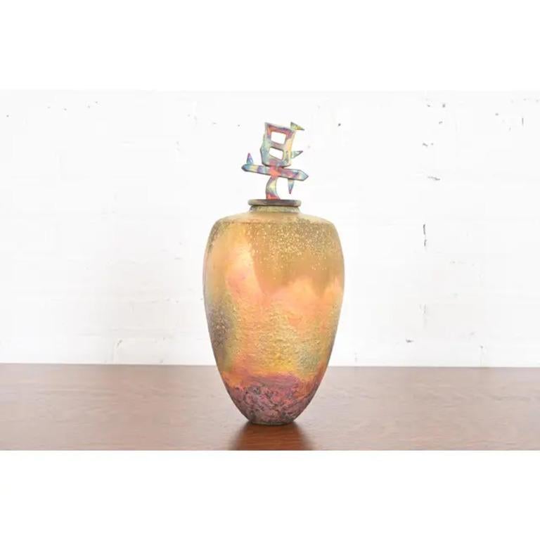 A gorgeous Japanese Raku Arts & Crafts glazed ceramic art pottery vase or vessel with Japanese character finial lid

Japan, Circa Mid-20th Century

Measures: 6