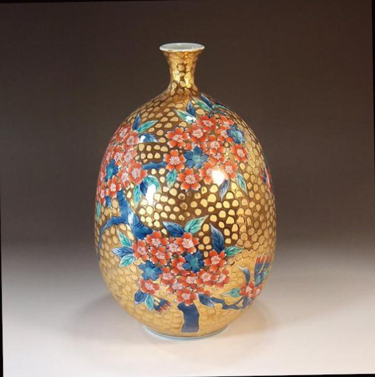 Japanese contemporary gilded and dimpled porcelain vase decorated with cherry blossoms in iron red, signed work by widely respected master porcelain artist in the Imari-Arita style and the recipient of numerous awards for his exceptional porcelain
