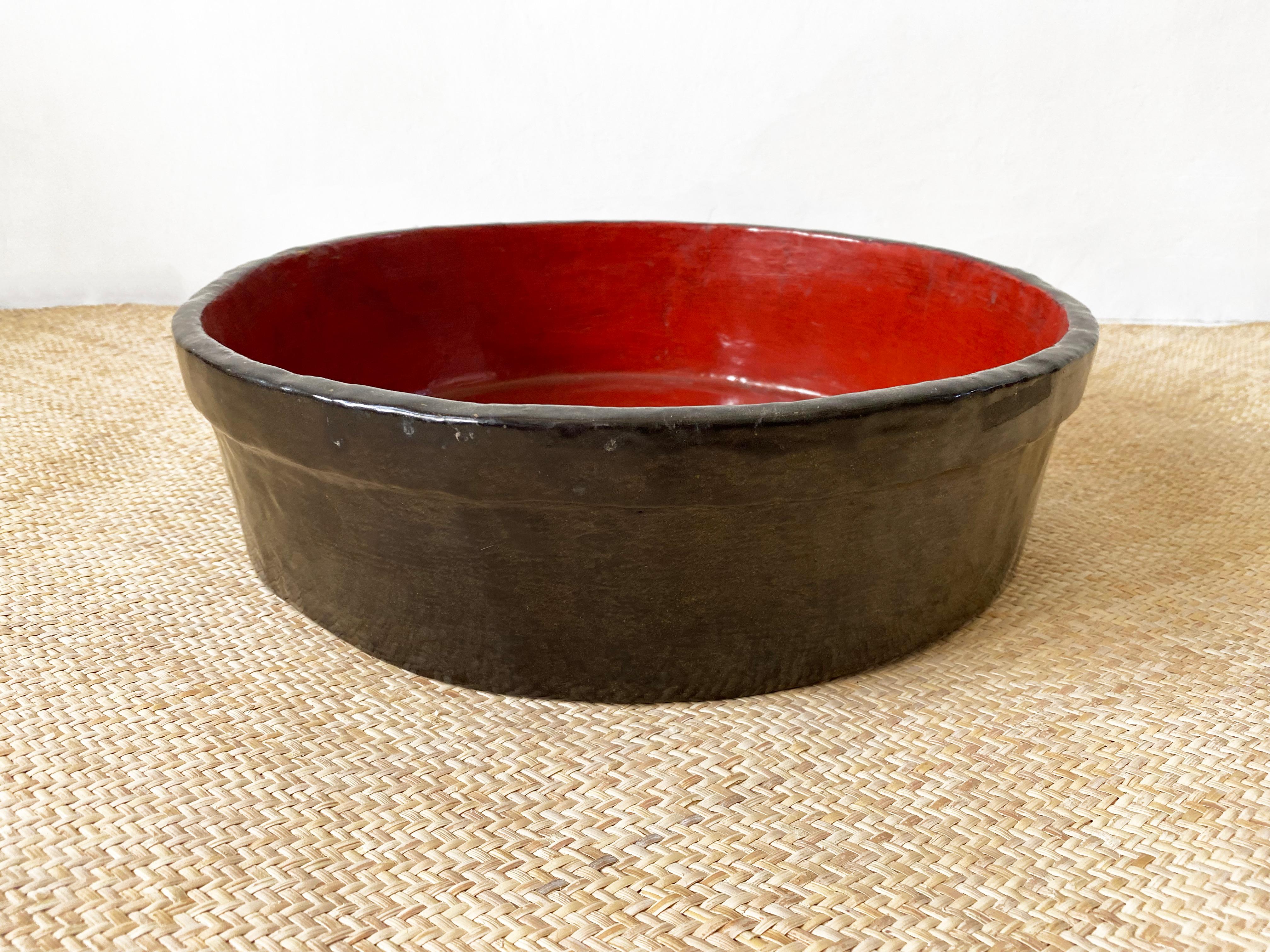 A Japanese red & black lacquer wooden bowl from the early 20th century. It is carved from a block of what is likely to be fruit wood. The bowl has aged beautifully over the years with small cracks and fading of the original lacquer.

The bowl is