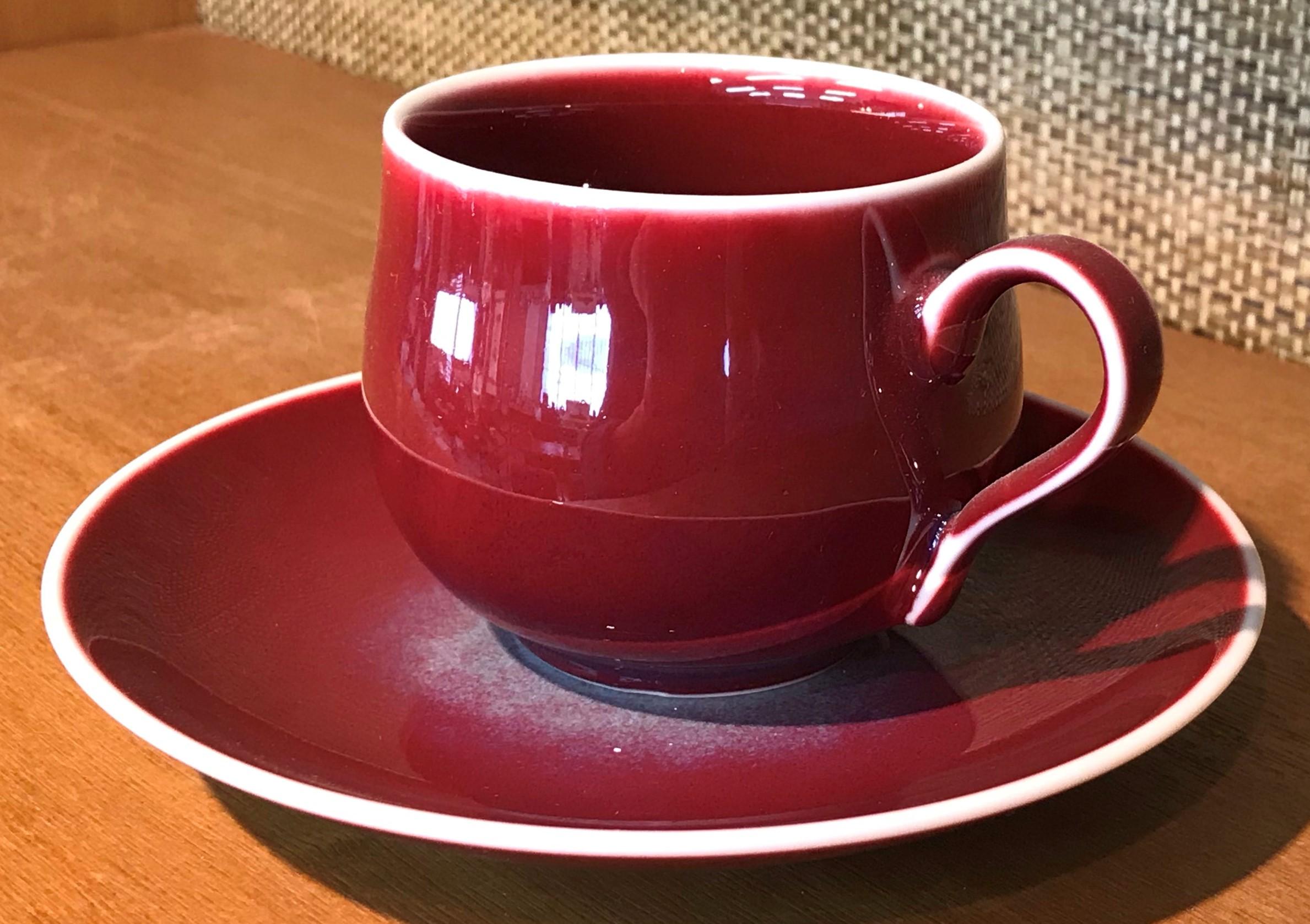 Exquisite contemporary Japanese porcelain cup and saucer, hand-glazed in stunning signature wine red, a signed work from an exclusive series of cups and saucers by highly acclaimed award-winning master porcelain artist from the Imari-Arita region of