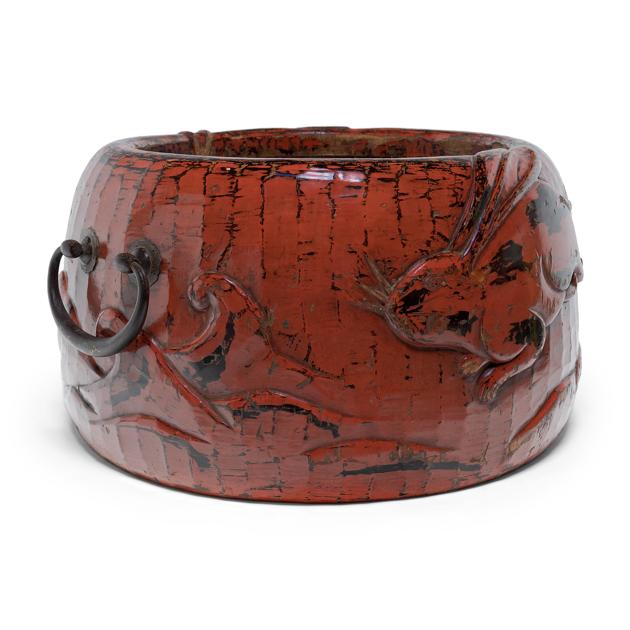 With monumental scale and beautiful, hand-carved details, this remarkable red lacquer hibachi is a true work of art. Designed to hold glowing embers, hibachi vessels such as this were used for cooking or as a source of heat in Japanese homes. Placed