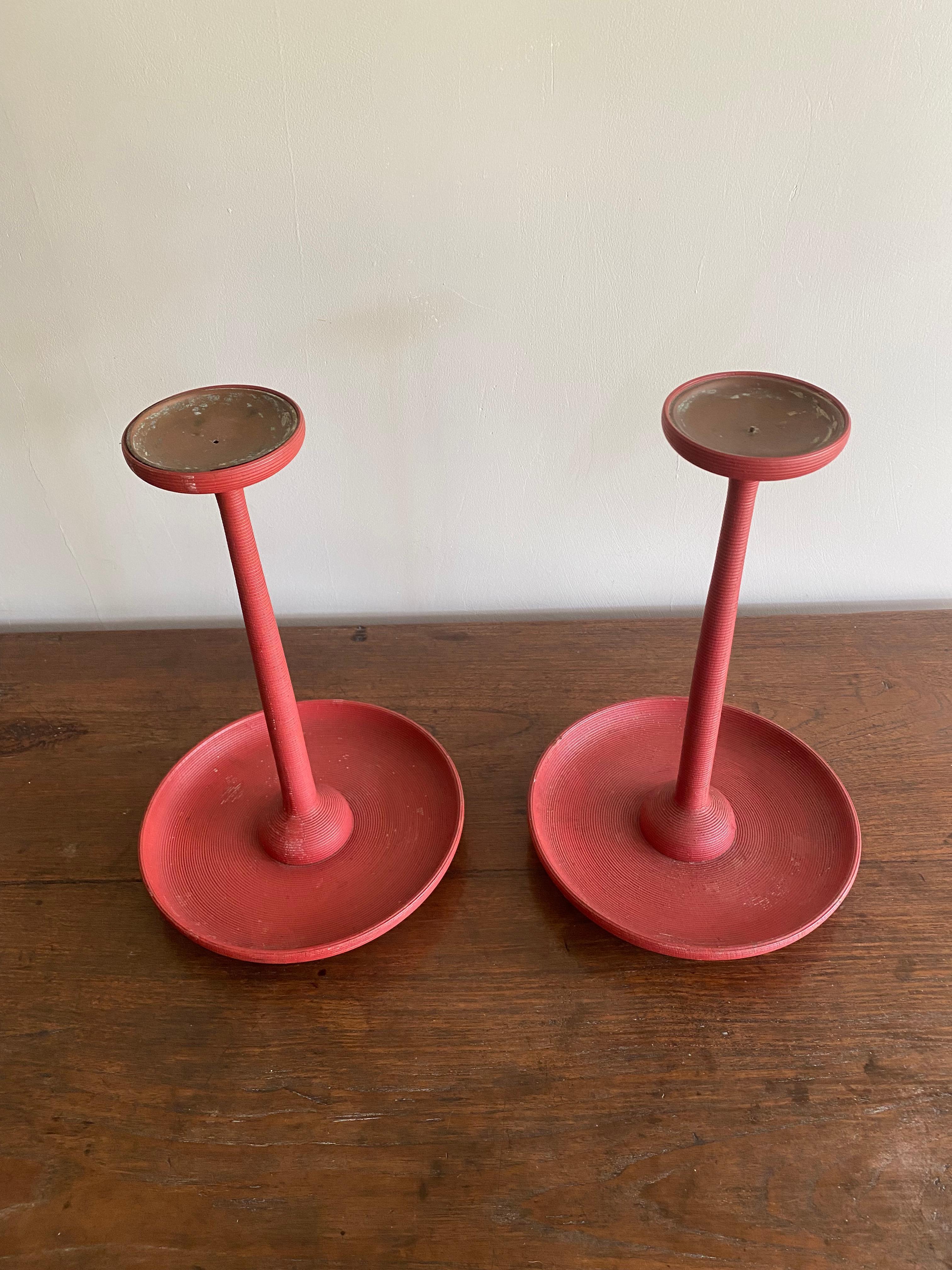 This stunning pair of Japanese red lacquered candle holders are exceptionally rare. They feature an elegant circular design with full height ribbed patterning. They are crafted from wood and a bright red lacquer coating. 

Dimensions: Height 36cm x