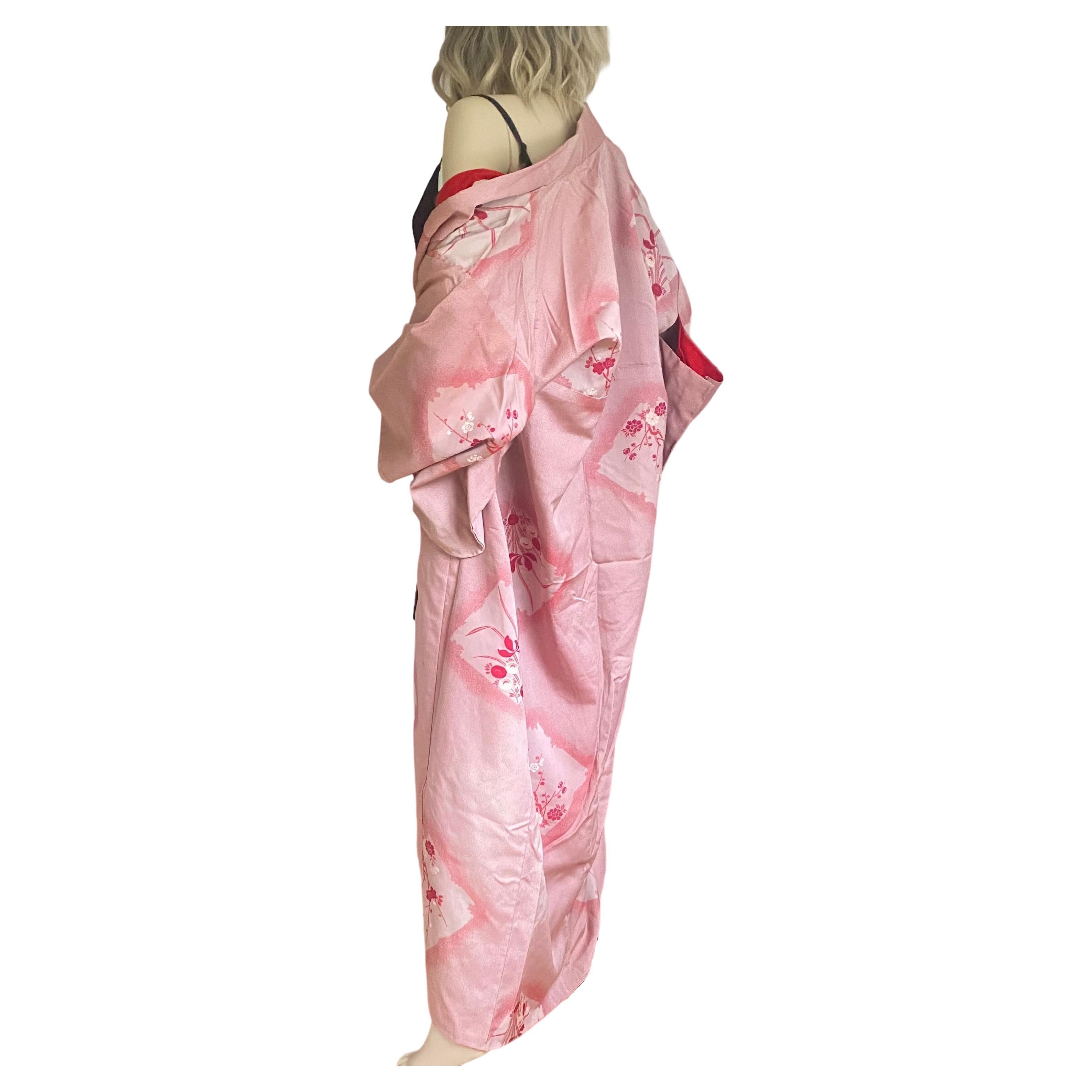 Circa: MEIJI period 1890
Place of Origin: Japan
Material: Substantial Silk brocade
Condition: excellent
Red/pink silk brocade kimono is hand-sewn and made in Japan.
Exquisite design of sakura (cherry blossom) branches  
Red silk lining.
Rare