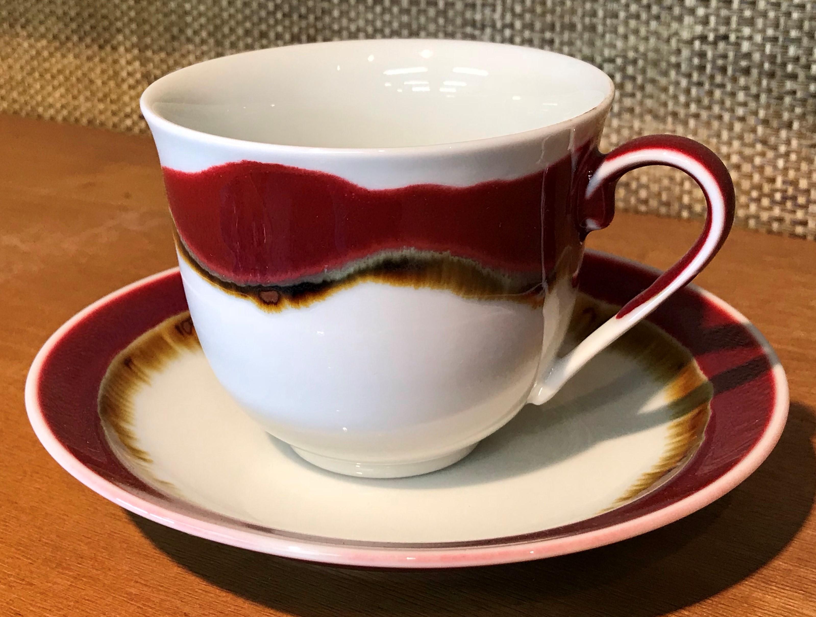 Exceptional Japanese contemporary porcelain cup and saucer, hand-glazed in a striking ruby red and blue on a beautifully shaped body. This is a signed work by a highly acclaimed award-winning master porcelain artist from the Imari-Arita region of