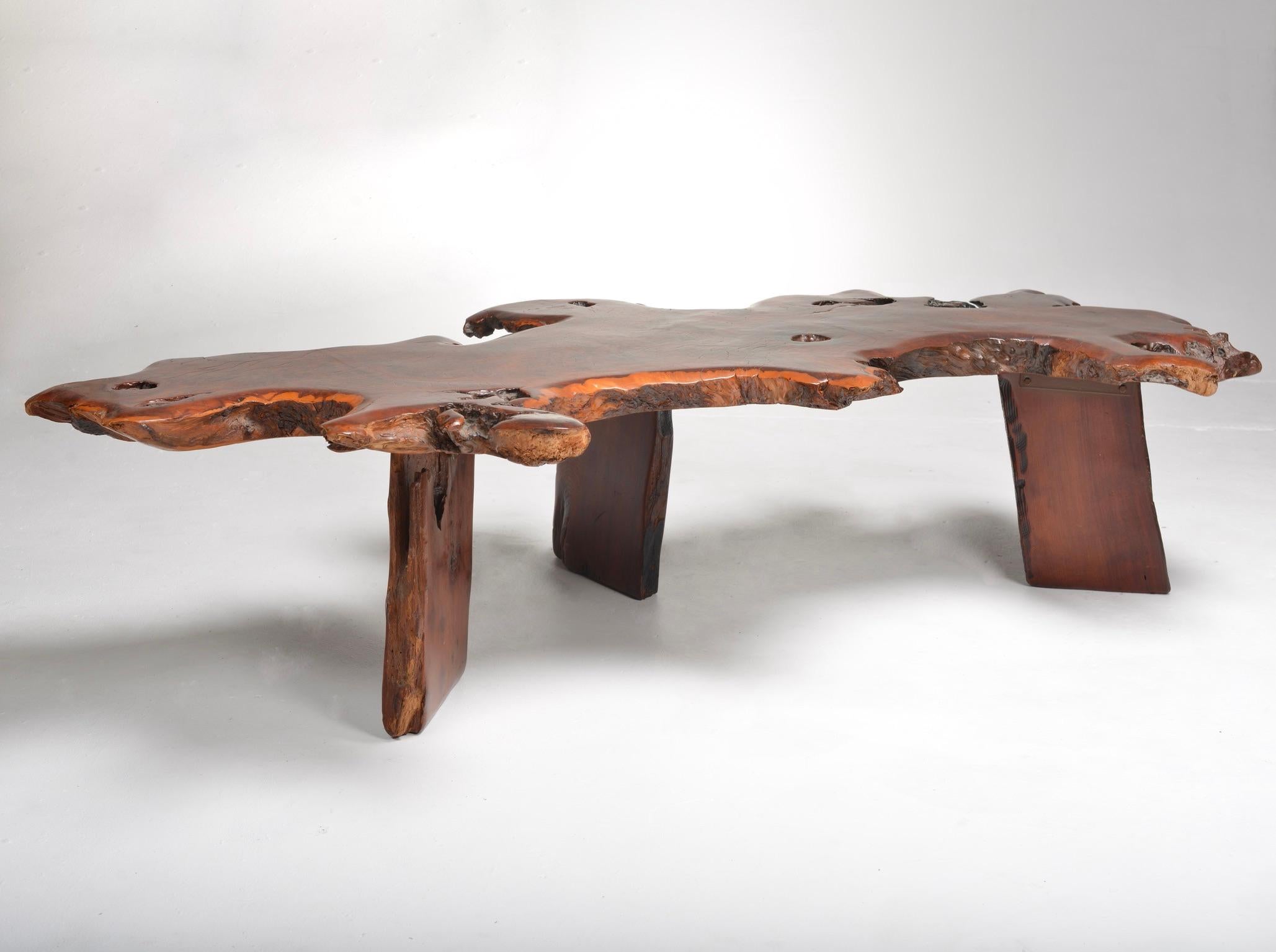 Large live edge Japanese red wood coffee table. The organic nature of this piece allows for room flow while bringing natural elements into your space. The wood has been treated and sealed with an epoxy finish to protect and enhance the material. 