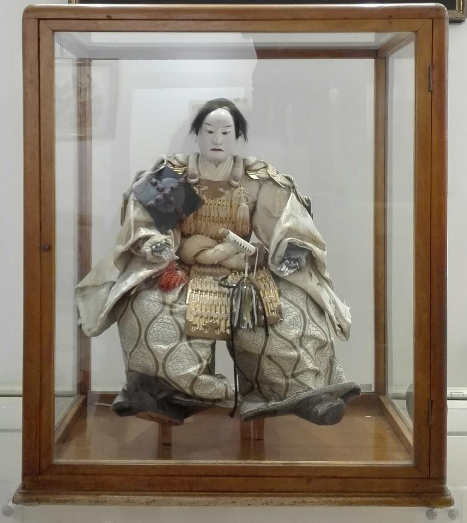 japanese samurai doll in glass case