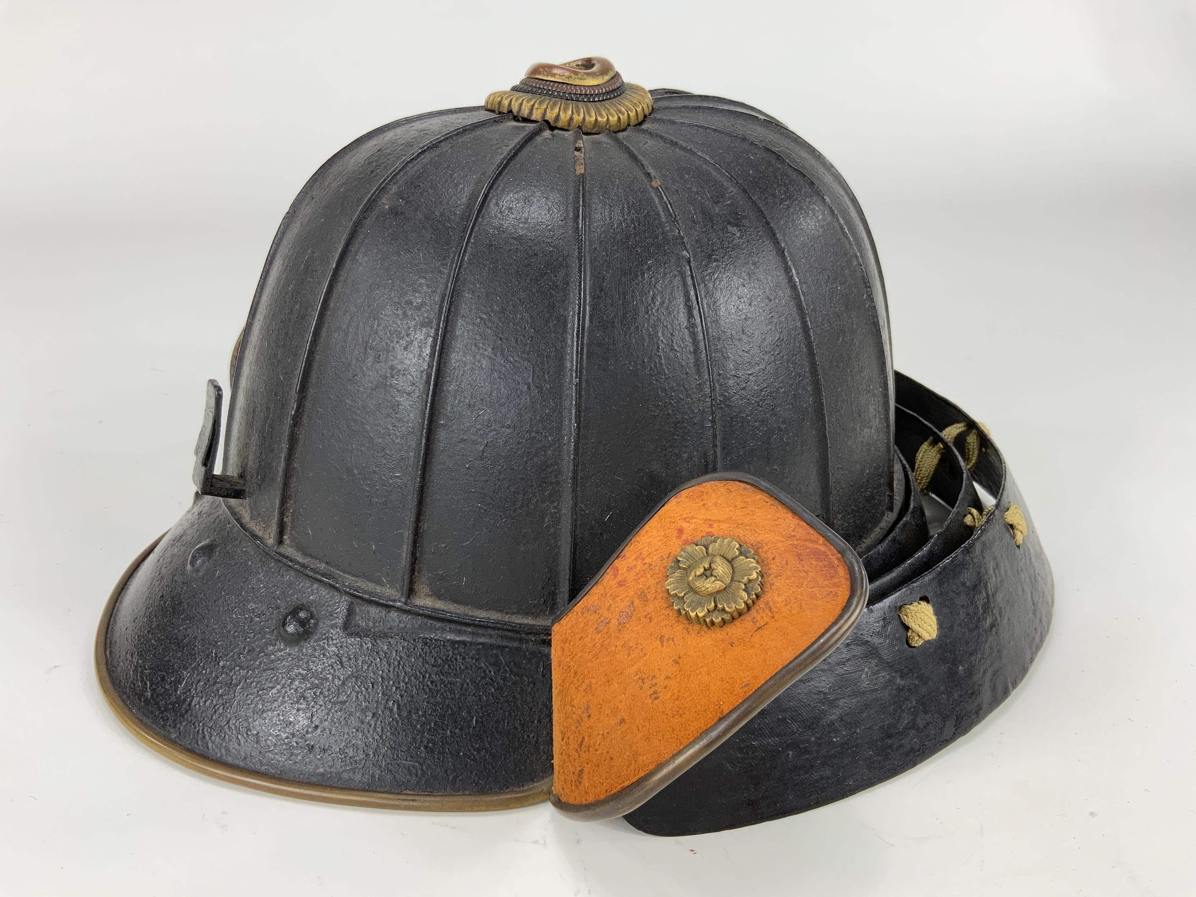 A Japanese Samurai black-lacquered helmet (kabuto) in suji bachi style and of a  goshozan shape consisting of the:

- main dome (hachi) made from 16 plates in natural iron riveted together,
- neck guard (shikoro) made from 3 separate round-shaped