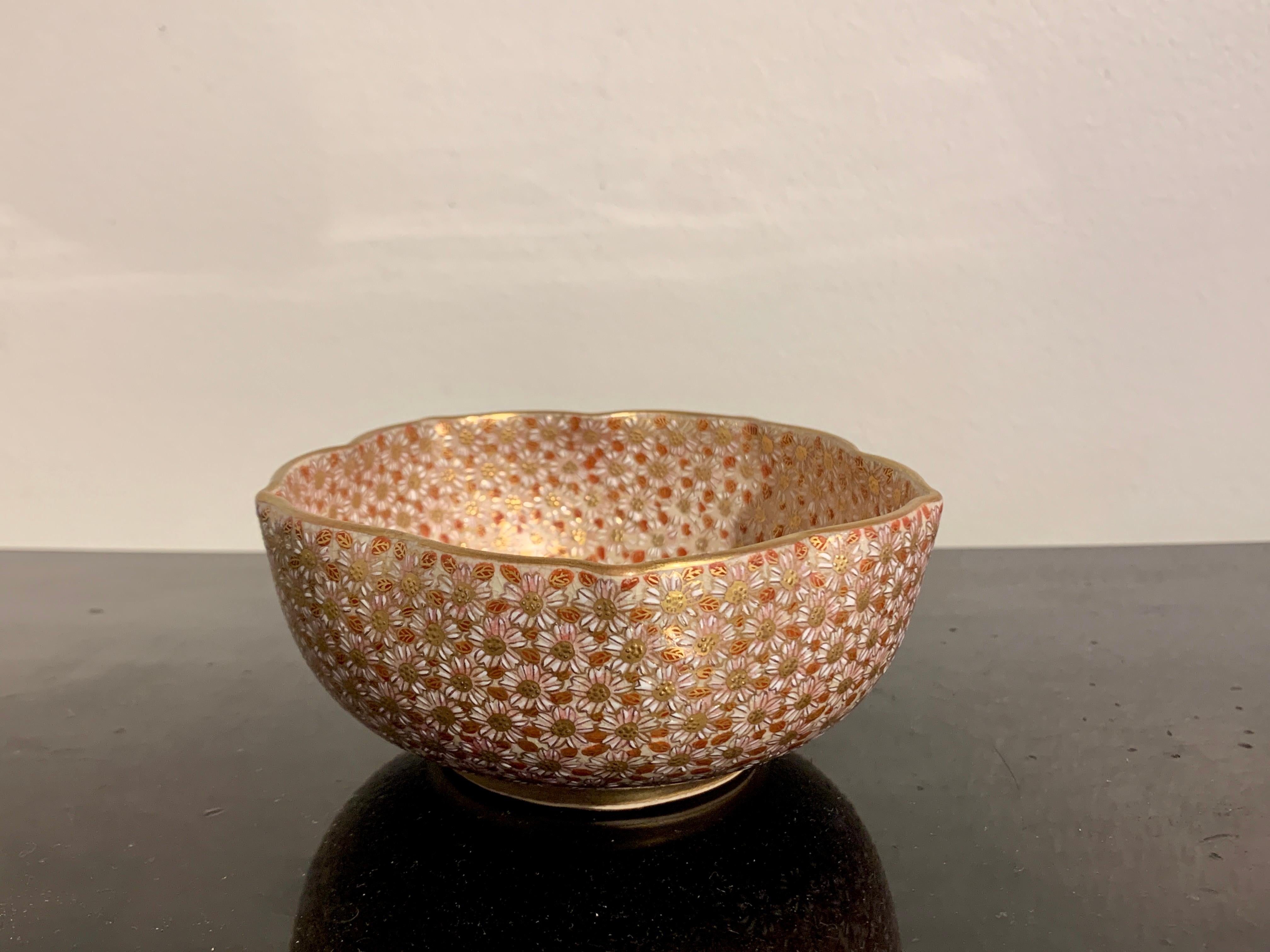 A meticulously decorated Japanese Satsuma chrysanthemum bowl, Showa Period, mid 20th century, Japan.

The bowl shaped as mallow (hibiscus) blossom. An intricate design of white chrysanthemum blossoms in raised enamels, with contrasting red and