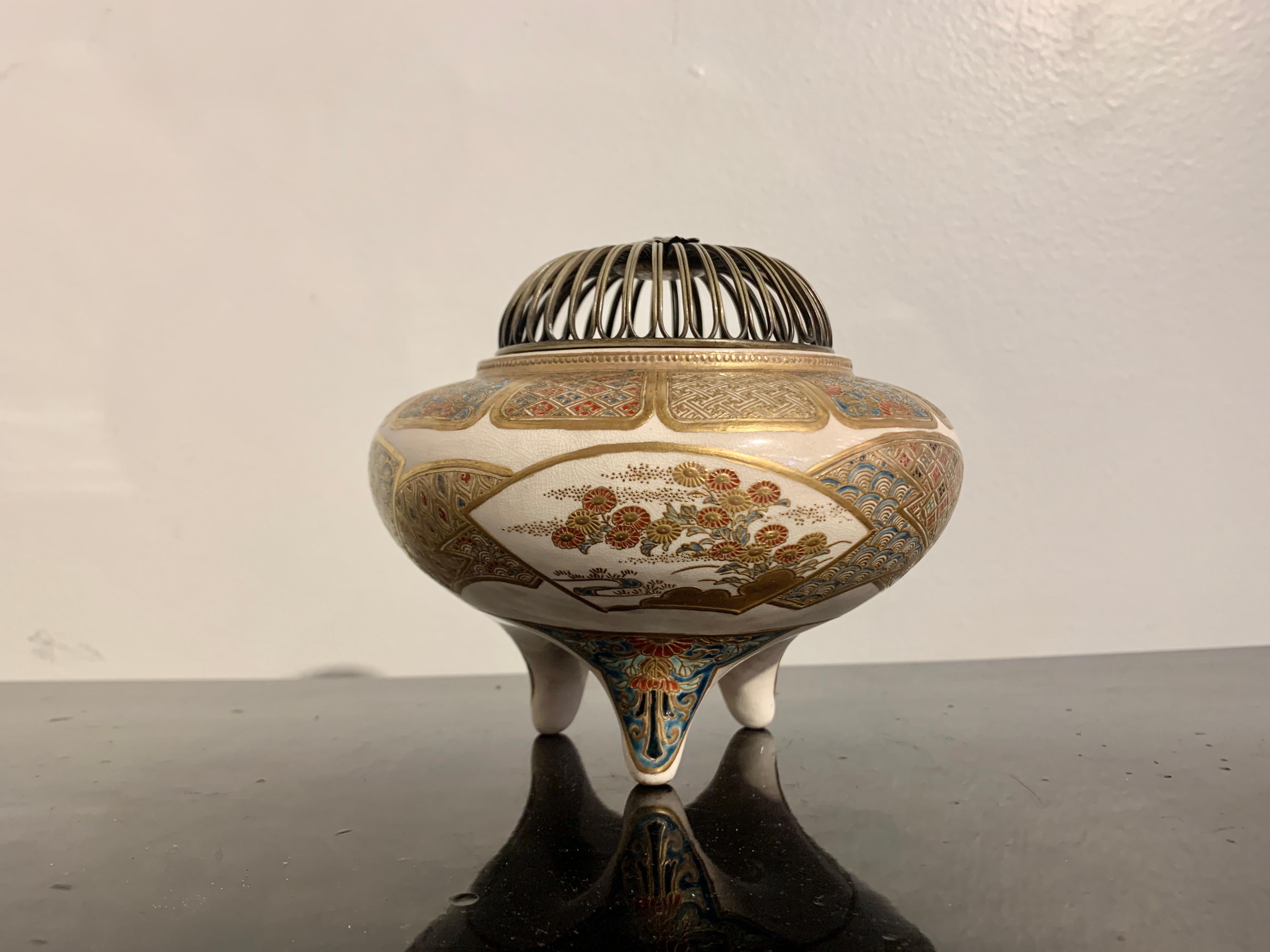 A fine and elegant Japanese Satsuma tripod incense burner, koro, with pierced metal lid, signed Eizan (?) Meiji Period, late 19th century, Japan.

The koro, or censer, features a stoneware body of slightly compressed globular form, supported on