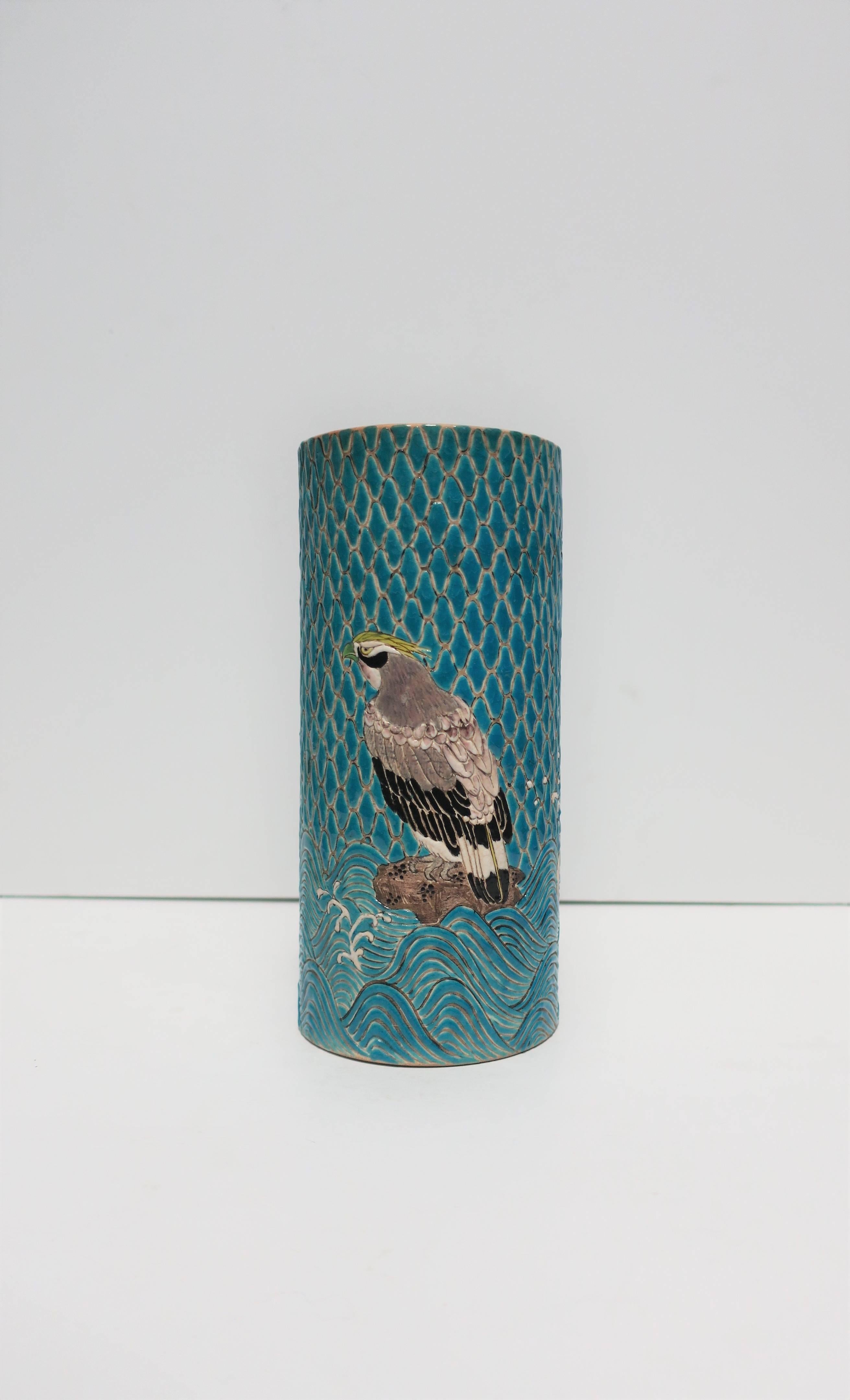 A beautiful Japanese Satsuma Majolica style earthenware vase, circa early-20th century, Meiji period, Japan. Vase is decorated with a beautiful tile-like exterior; a raised relief of crane birds, blue water and sky. Marker's mark on bottom as show